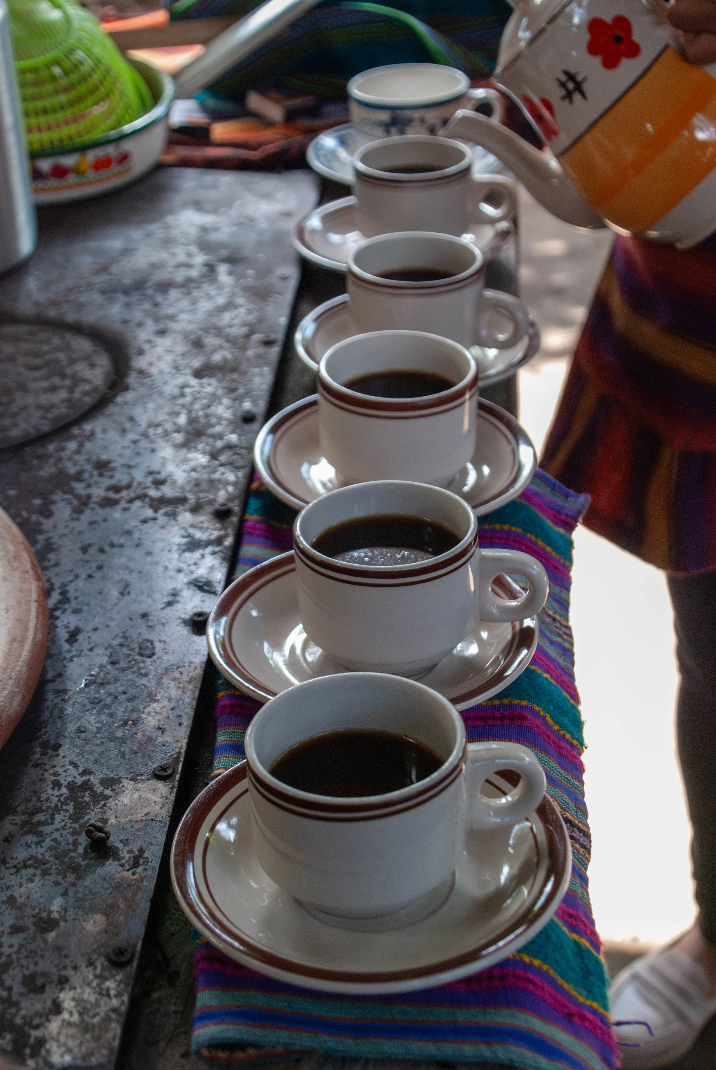 cups of freshly brewed Guatemalan coffee lined up over a woodfire stove | honoring our roots