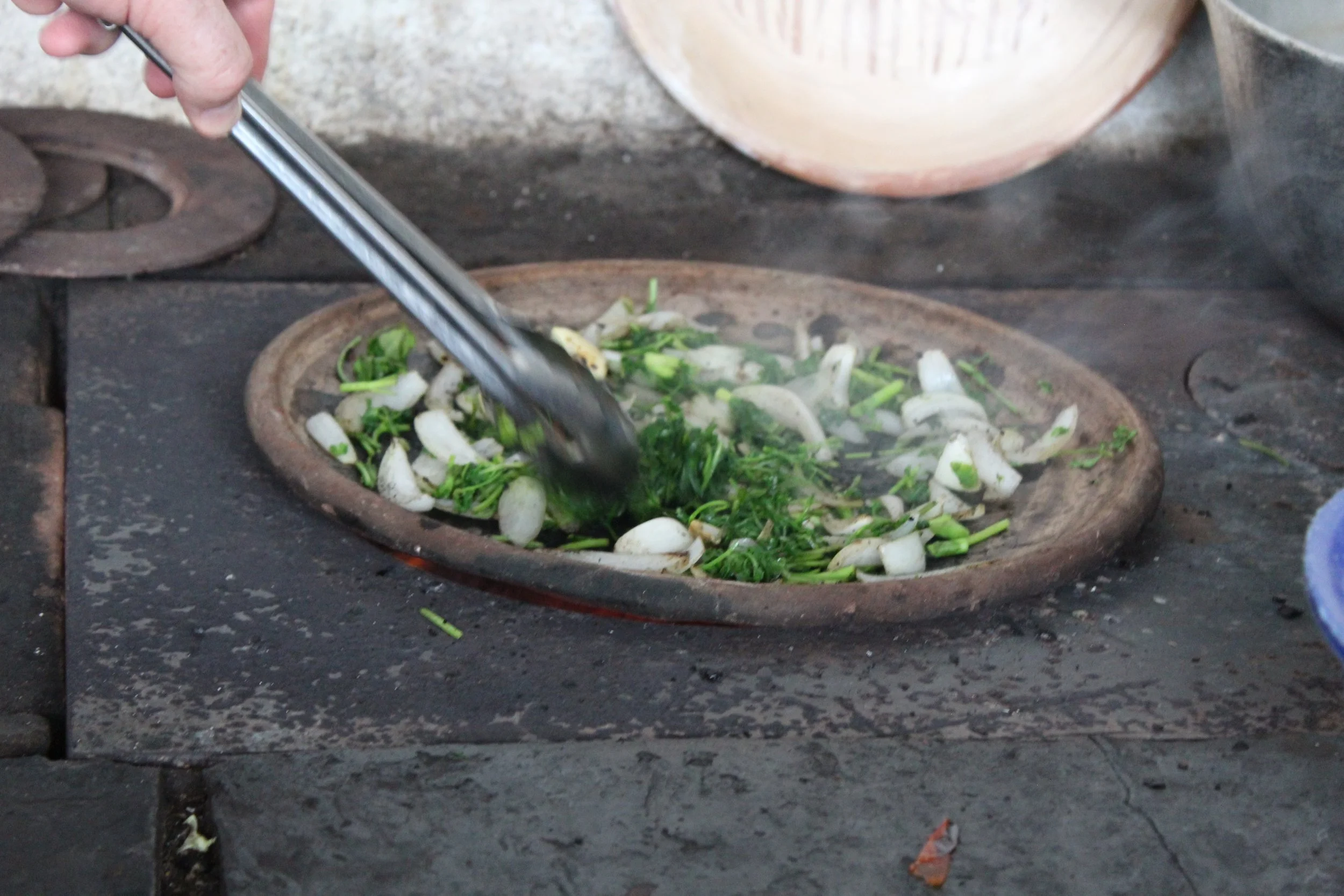 roasting ingredients for a traditional guatemalan dish on a clay pan | guatemalan cuisine