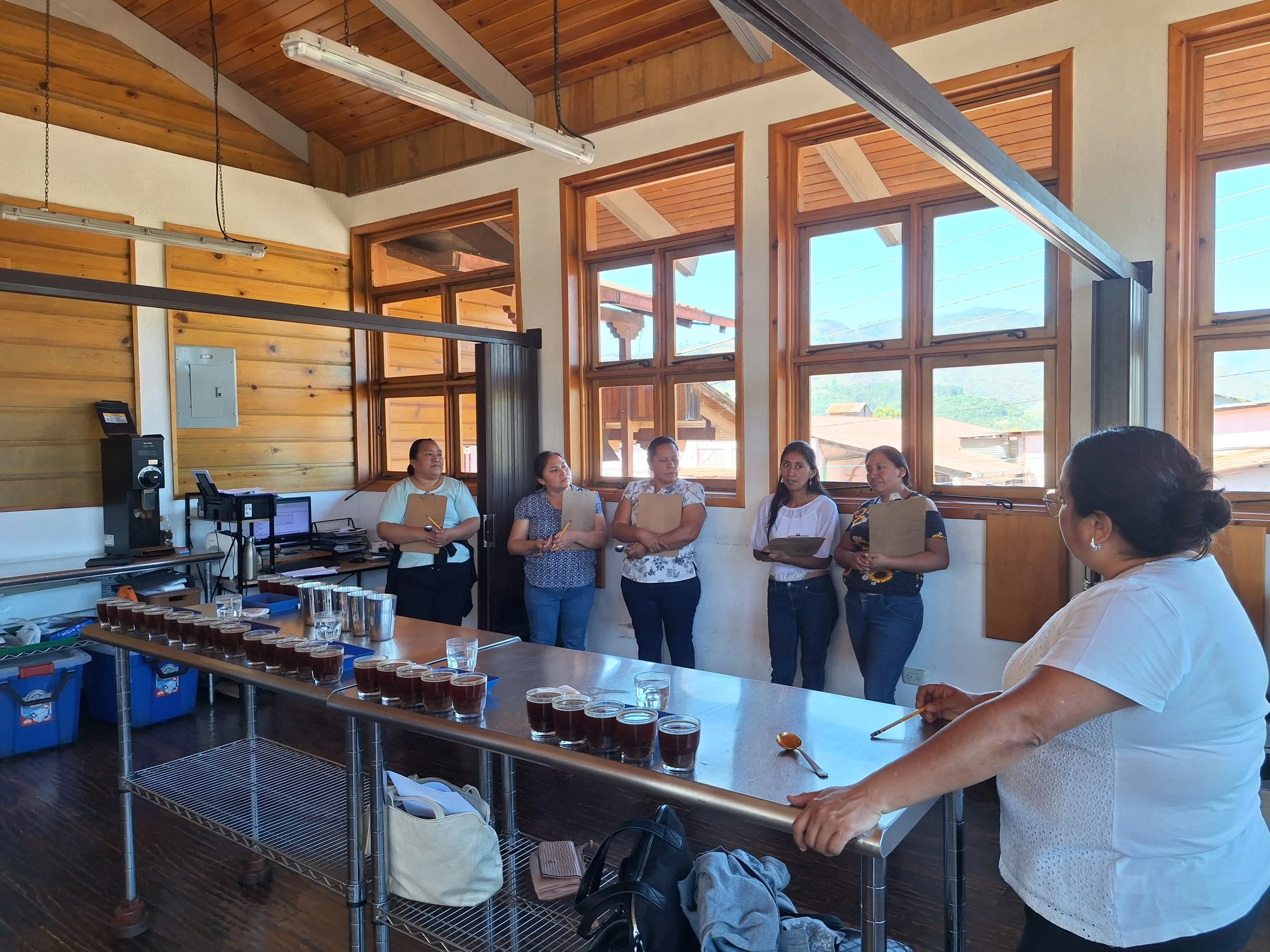 Women coffee producers at coffee sensory lab training with expert