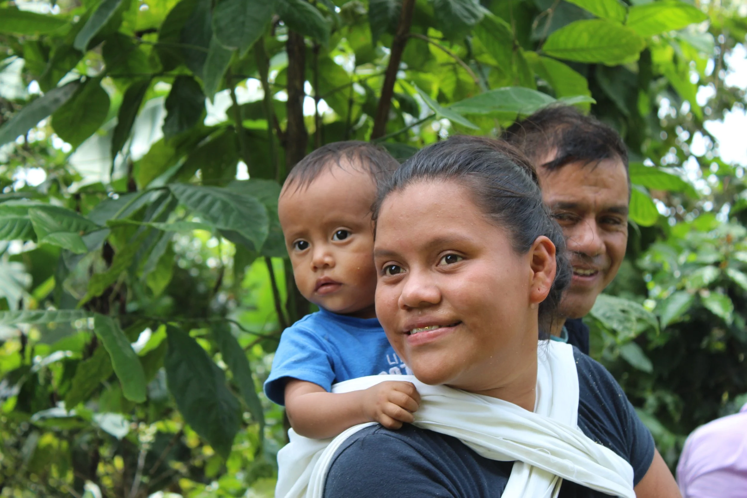 women coffee producer with his baby | honoring women in coffee | Coffee by women