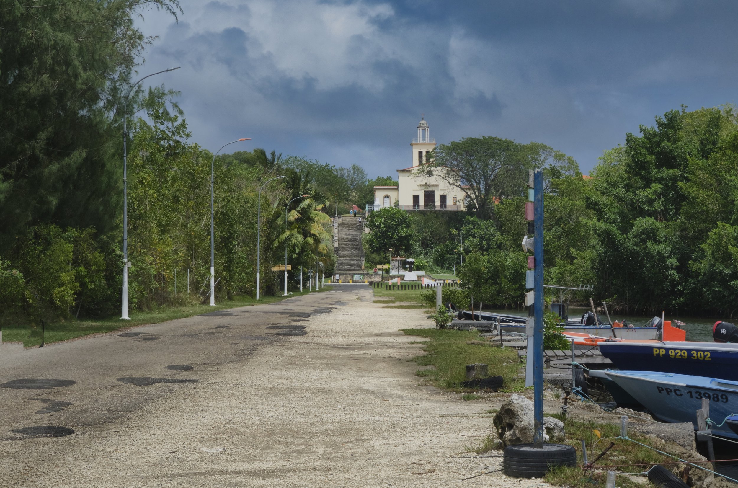 Standing beside the Petite Canal.  This canal was built in the 18th century.  It was designed for the arrival of slave ships.  About 45,000 enslaved men, women and children were brought here.  After disembarking, they walked to the church you see on 