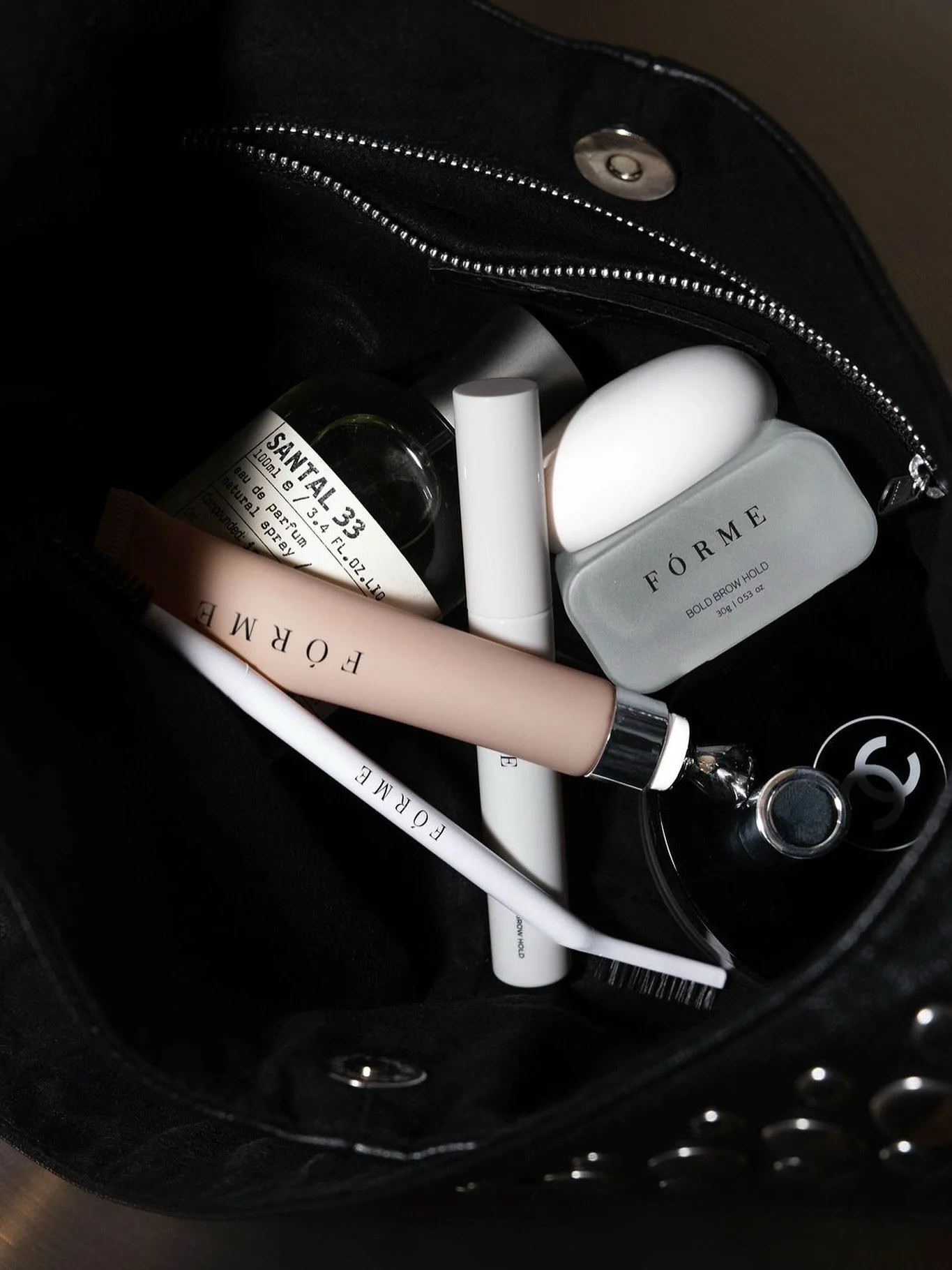 khaira on the arm, melbourne-designed and worn soft like your favourite leather jacket. Inside the bag: newcastle-brand, forme essentials &mdash; brow styling holds and sculpt wand, go-to gloss but it&rsquo;s a nourishing lip oil and a spritz of sant
