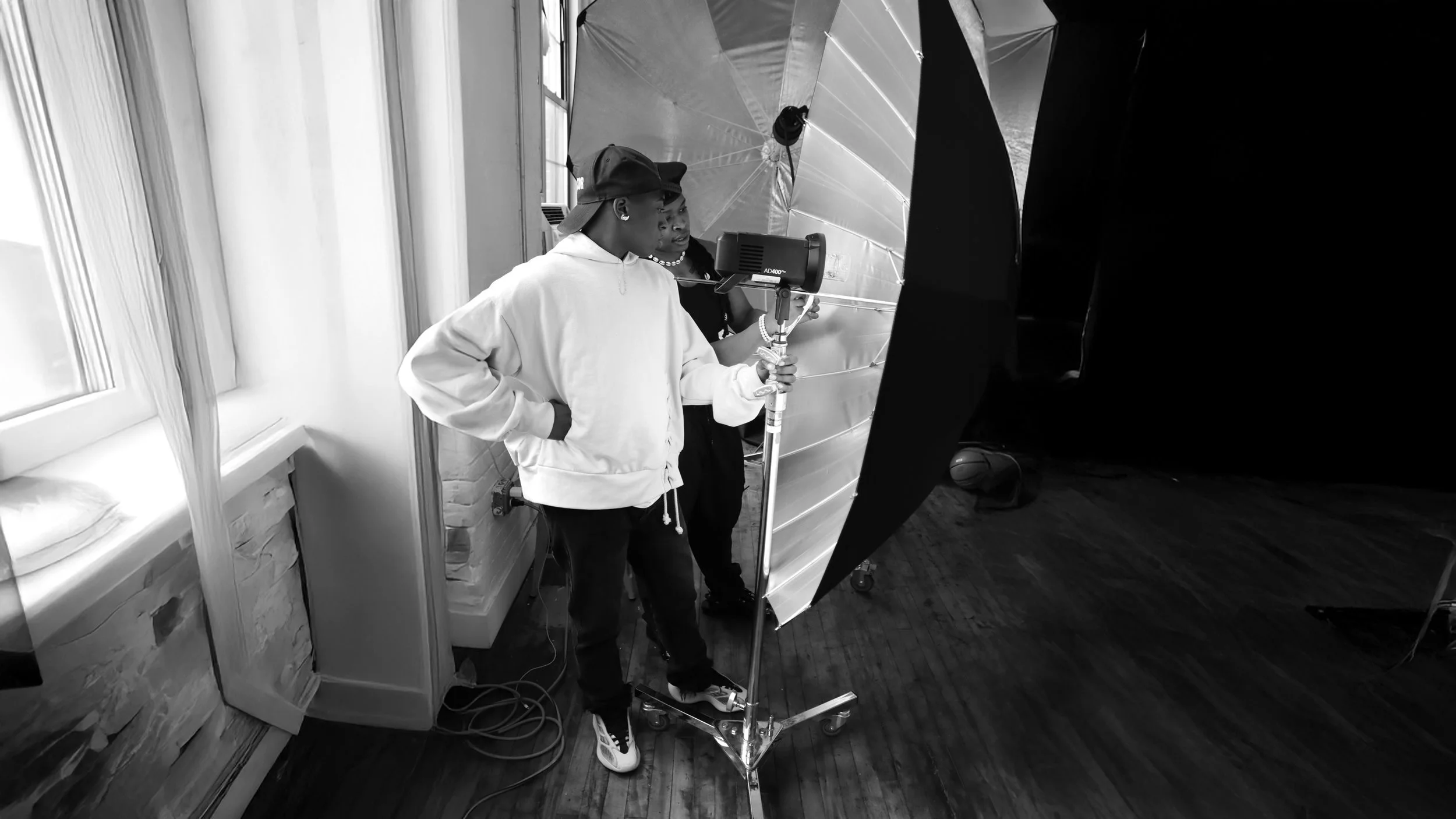 A Bronx Youth works with an industry professional as they learn the basics of studio lighting.