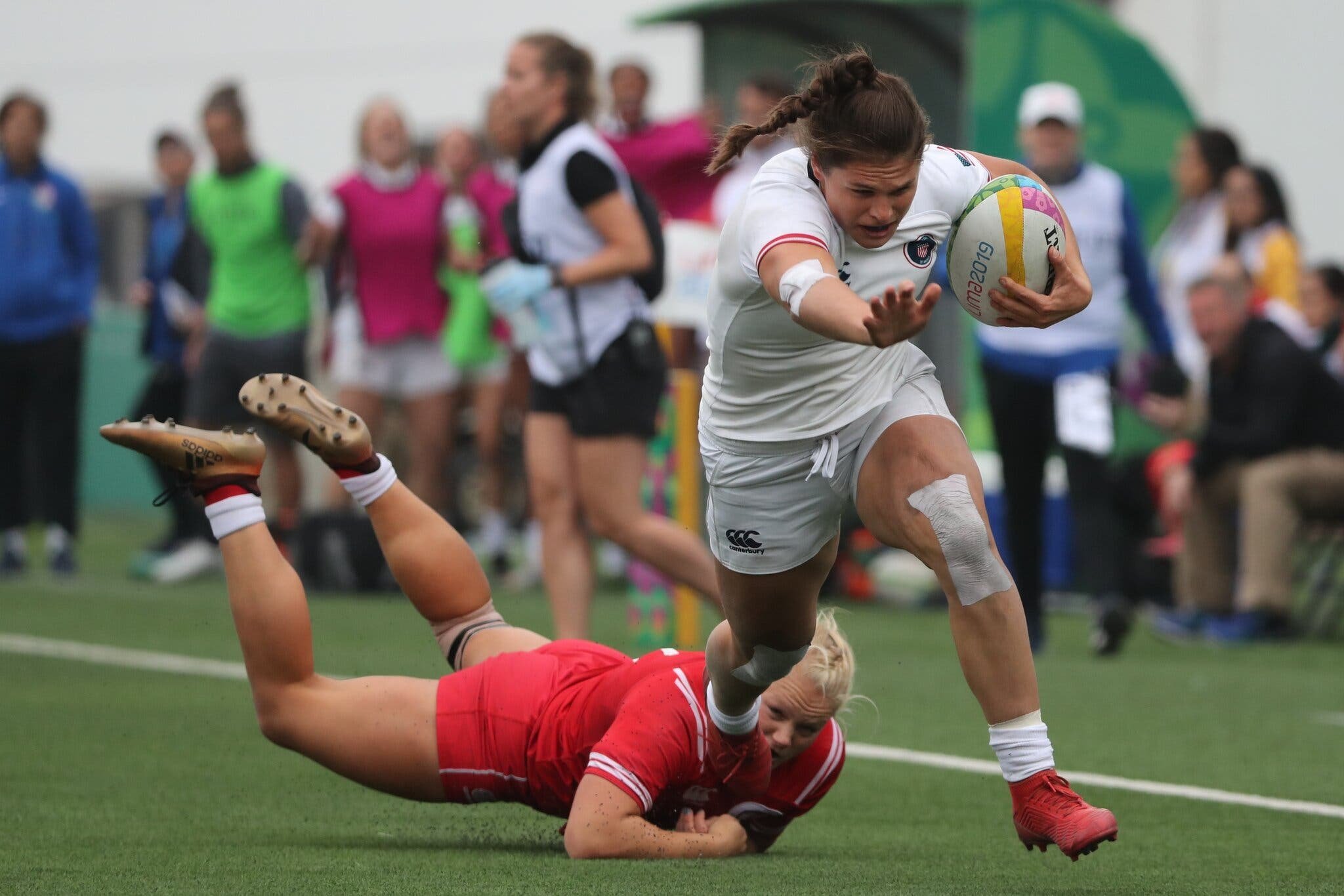 Ilona Maher runs through opponent in rugby game