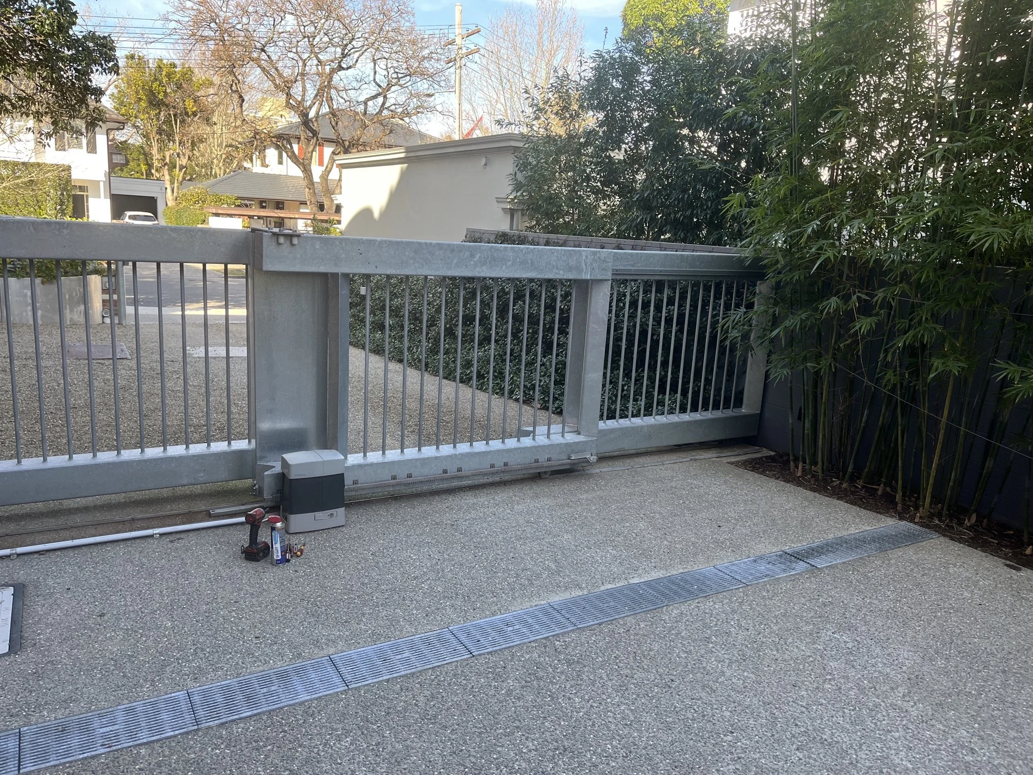 An Automatic Telescopic Sliding Gate Designed for a Wide Opening and Limited Run-Back Space
