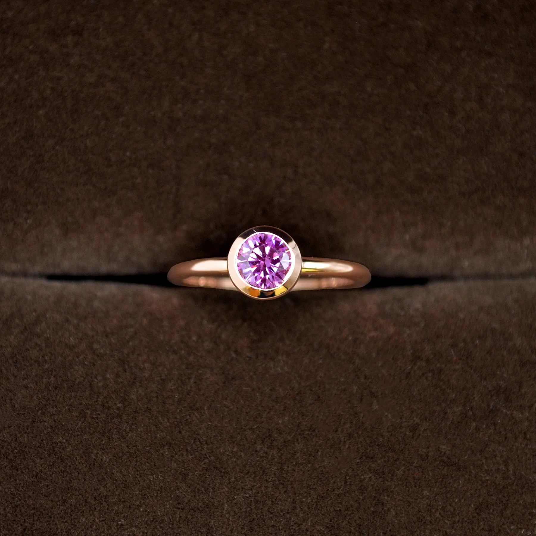 A shining custom platinum bezel pink diamond memorial ring.