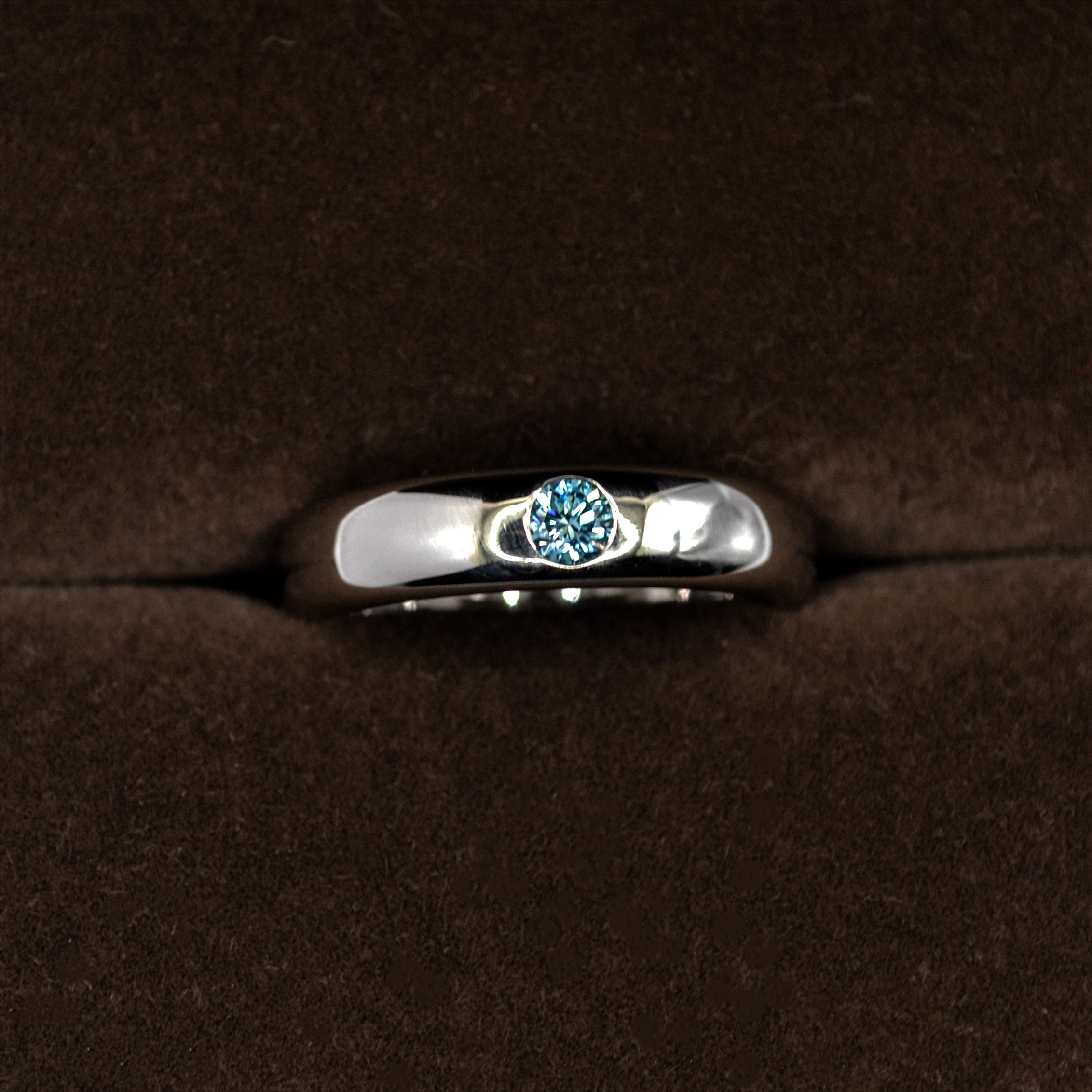 A fancy gypsy setting blue diamond ring.