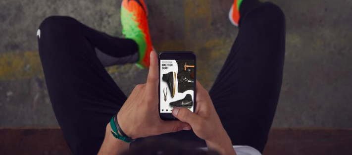 An athlete looking at their mobile phone.