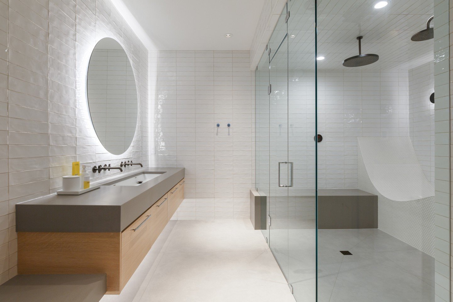 The initial challenge in the gym bathroom from our #IHRosedaleResidence was the lack of natural light. Through the use of both decorative and indirect lighting, we were able to fully light the space and highlight the texture of the fully tiled walls.