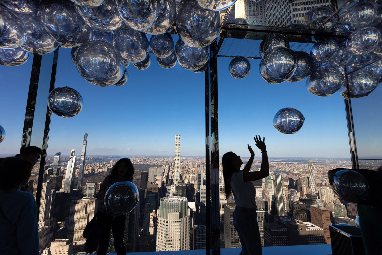 People with silver balloons at NYC observation deck.JPG