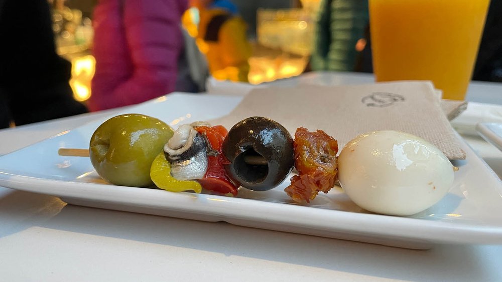 A skewer of anchovies, quail egg and olives