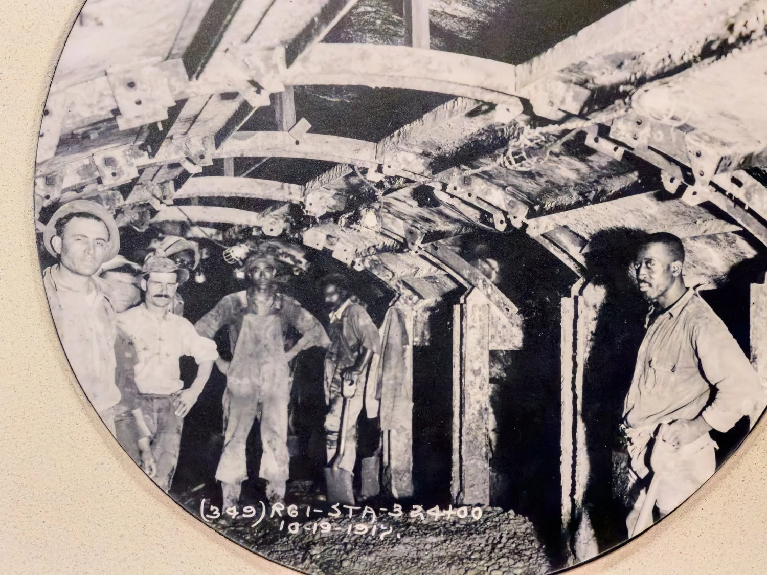 Exhibit photo of workers building a subway tunnel