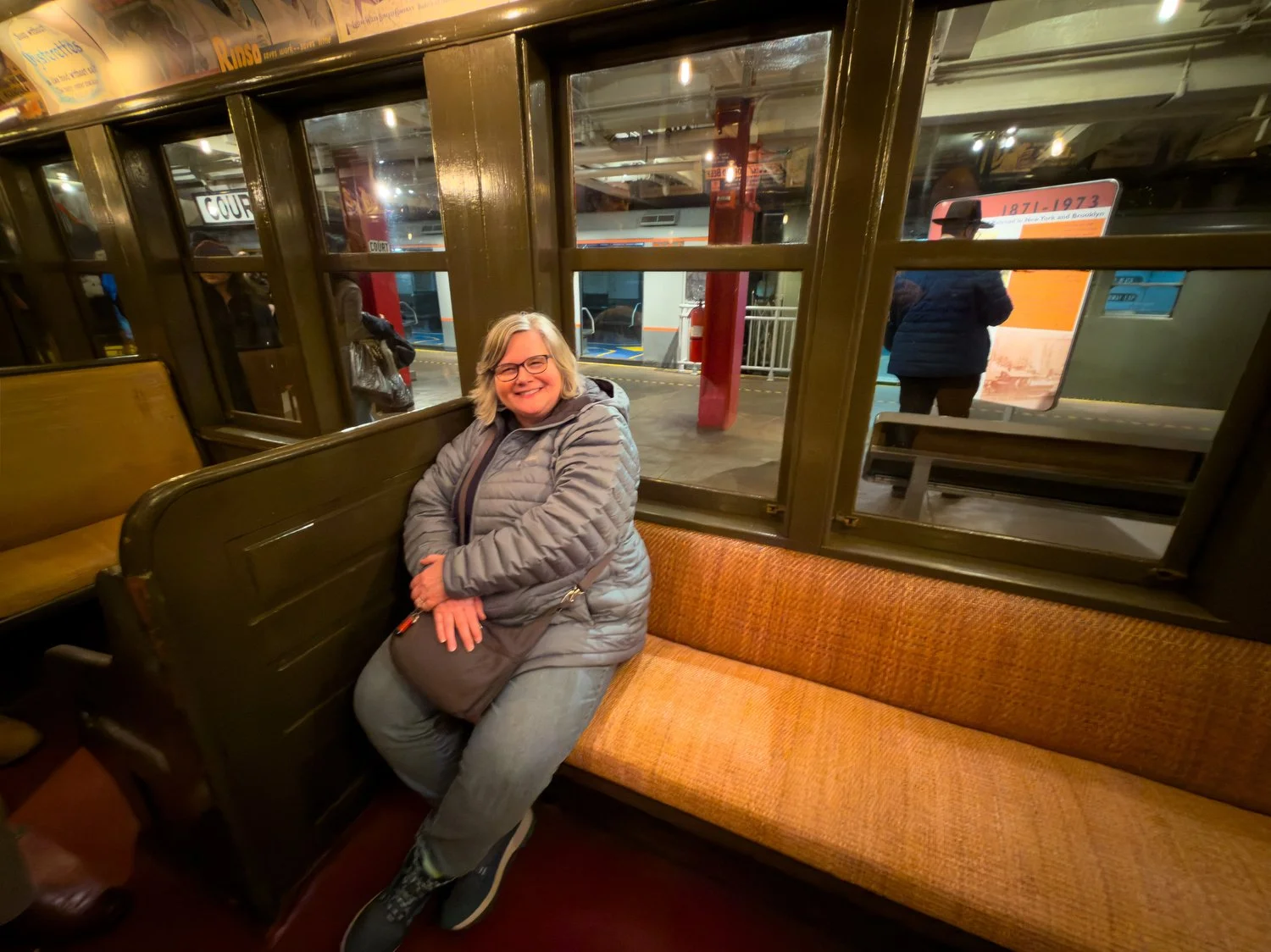 Debbie sits in a vintage subway car