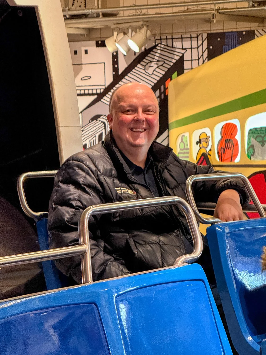 John sits in a bus display