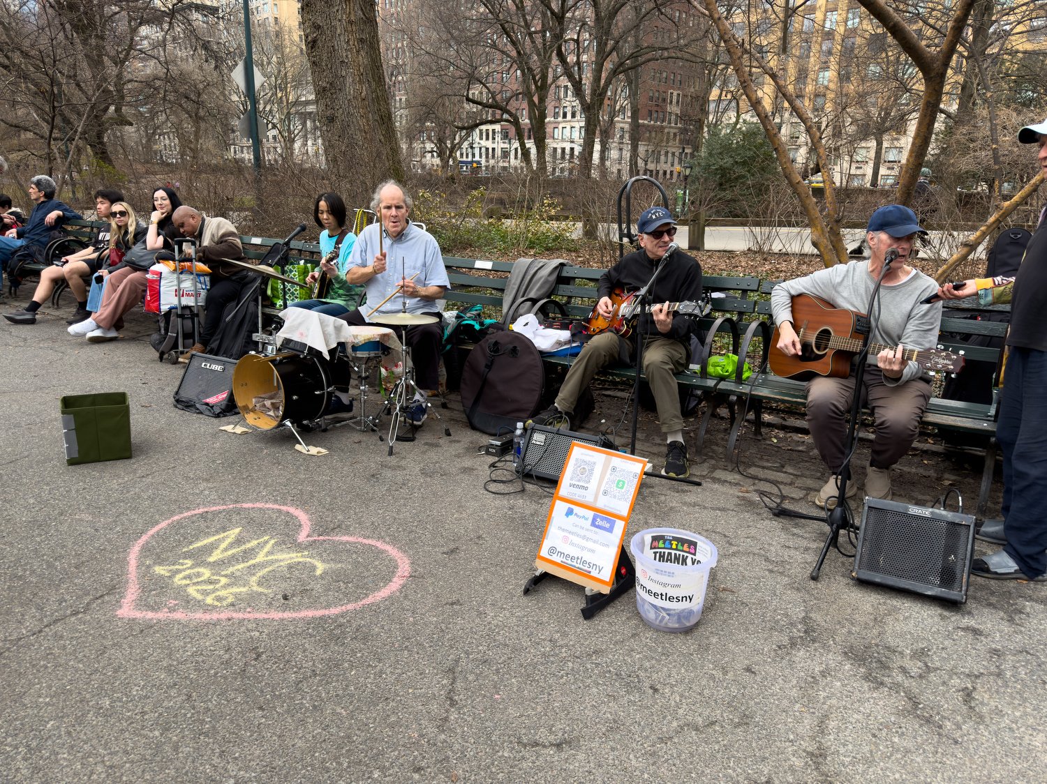 Musicians playing Beatles music in Strawberry Fields.