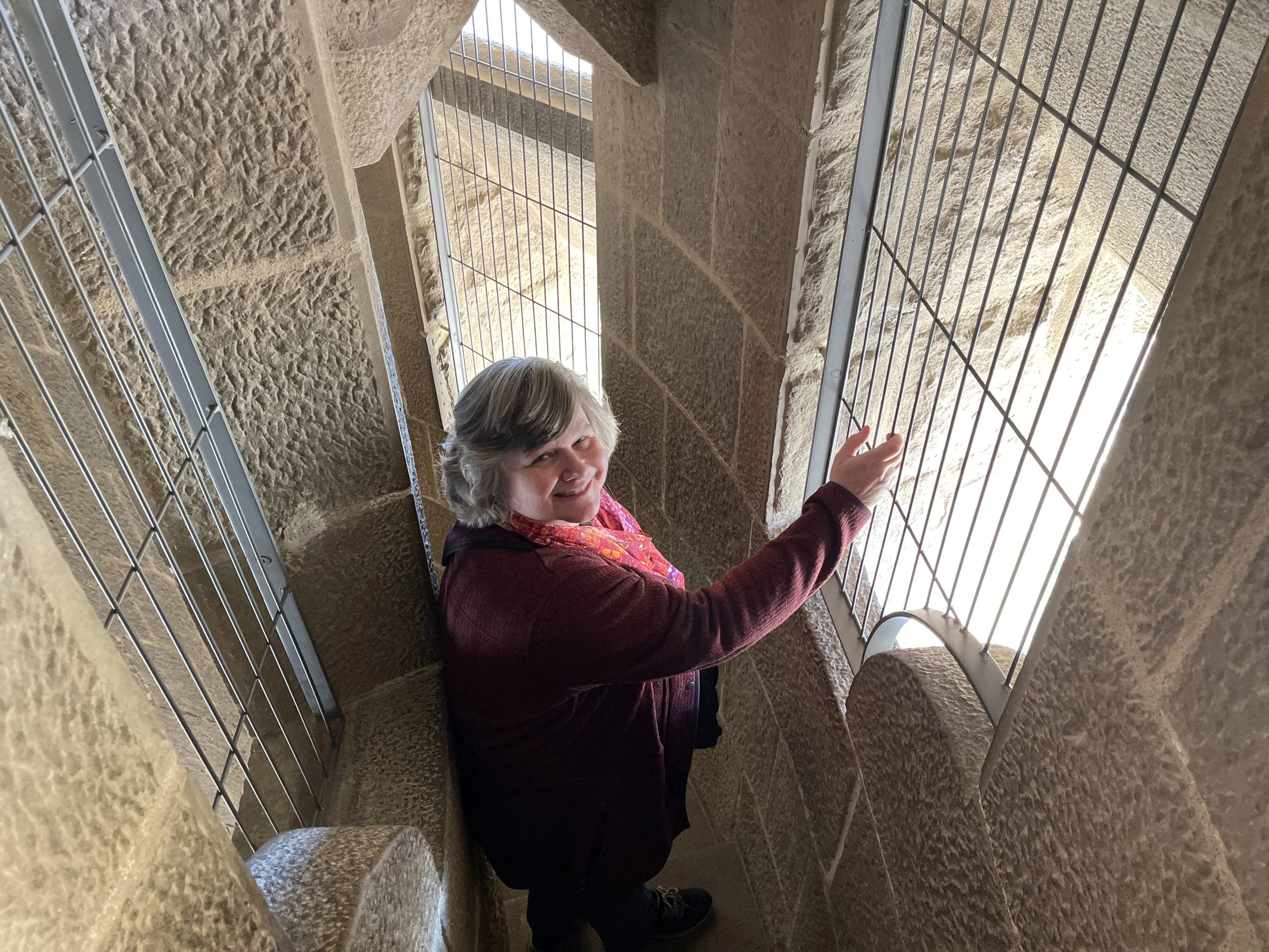 Debbie walks down the narrow steps of the Passion Tower.