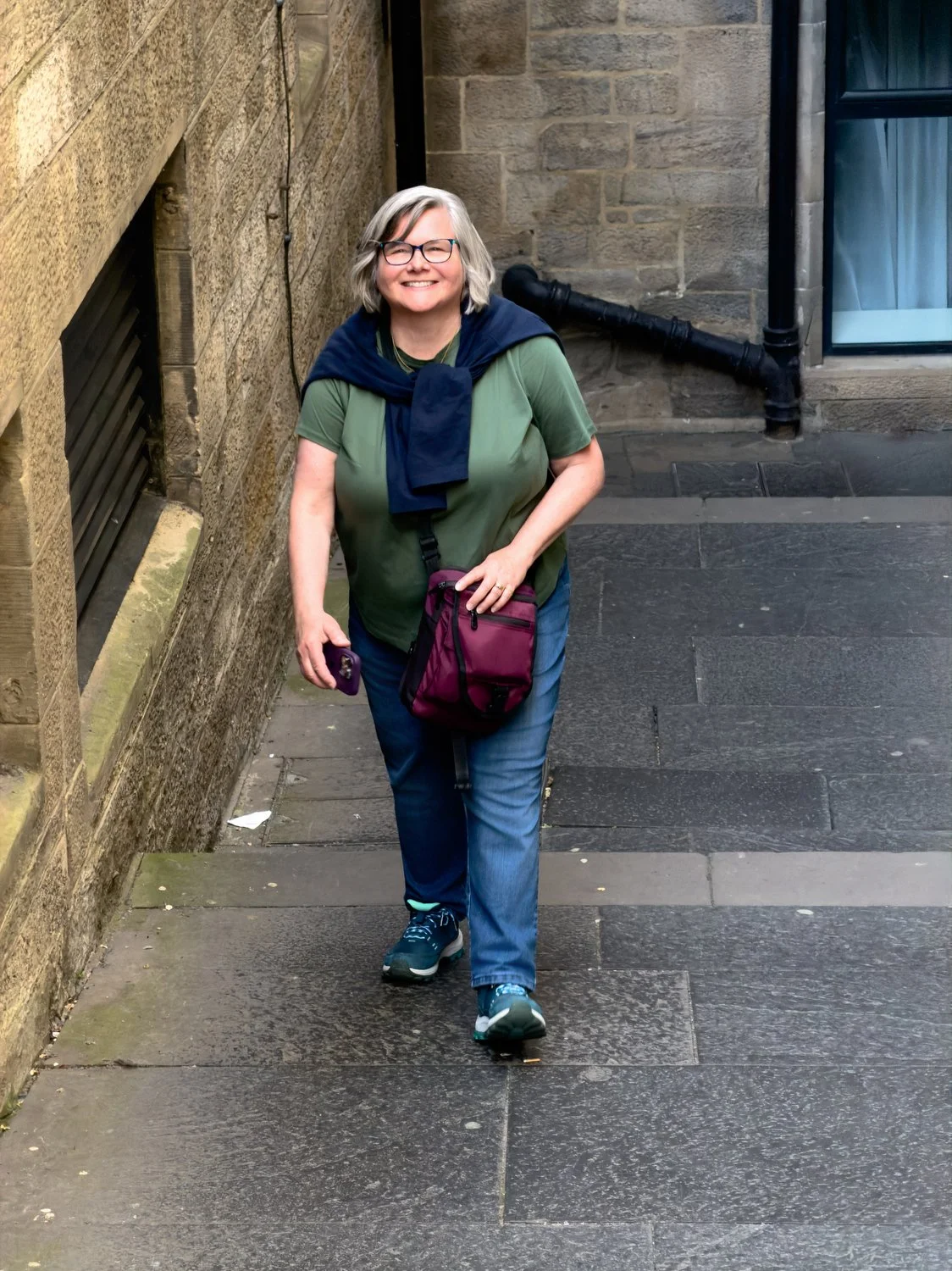 Debbie smiles in an alleyway off the Royal Mile.