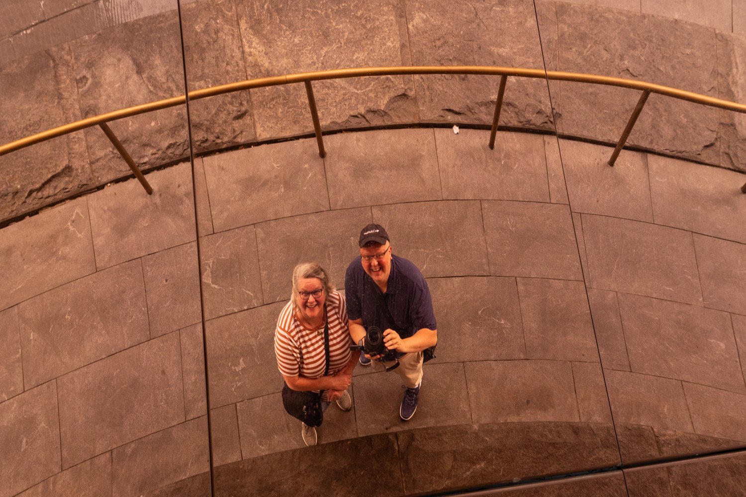 Debbie and Joh reflected in the shiny exterior of. the Vessel.