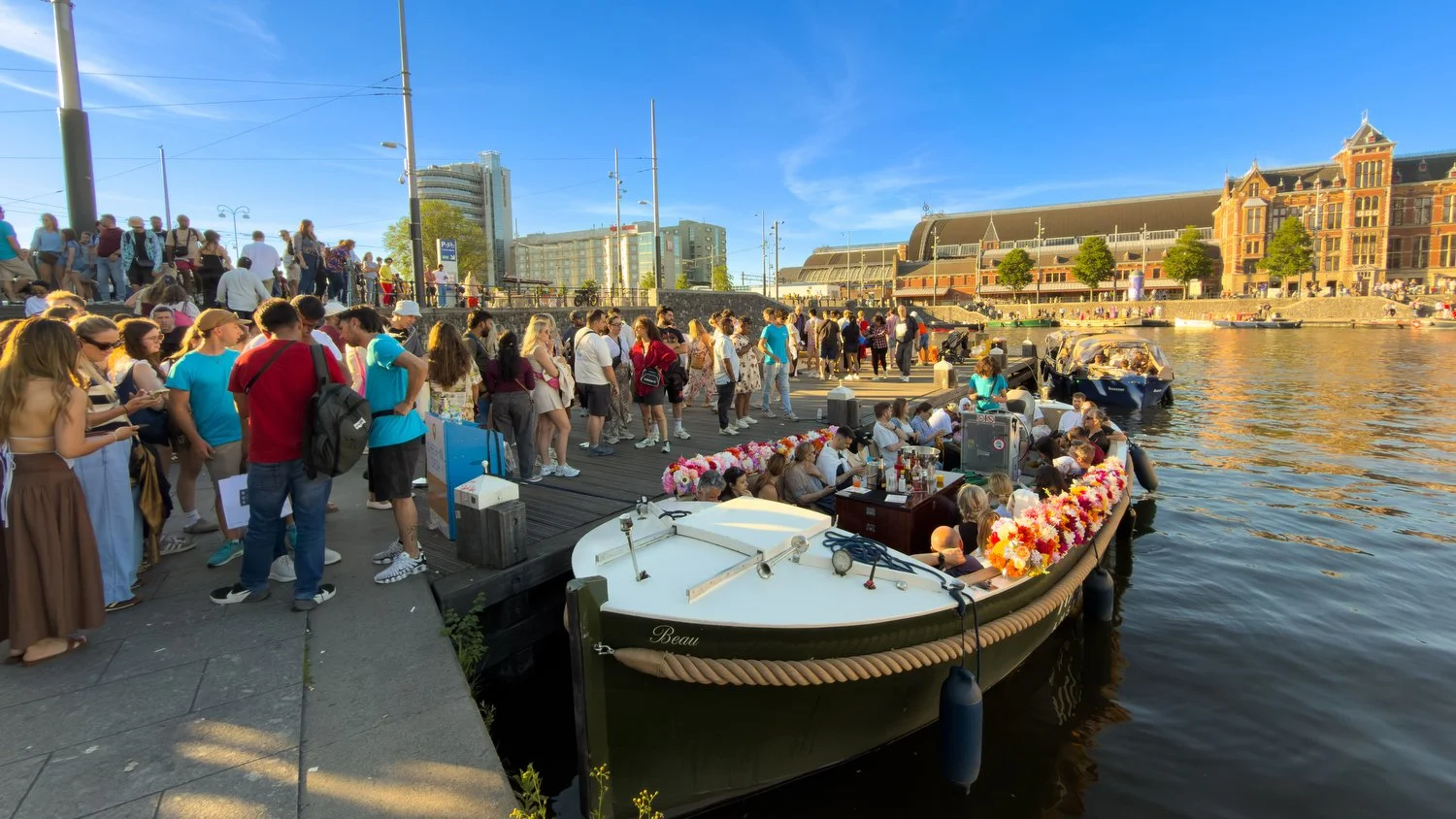 A crowd boards tour boats. 