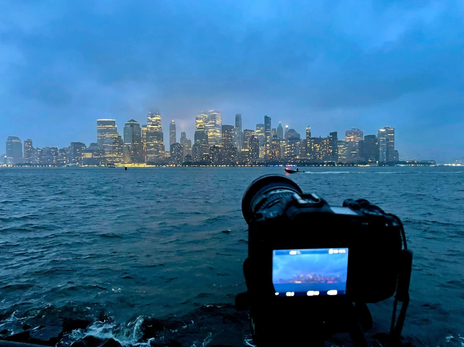 a camra photographs the nyc skyline at liberty state park