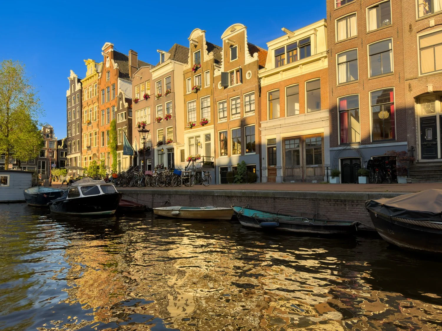 Amsterdam building reflected in a canal at sunset