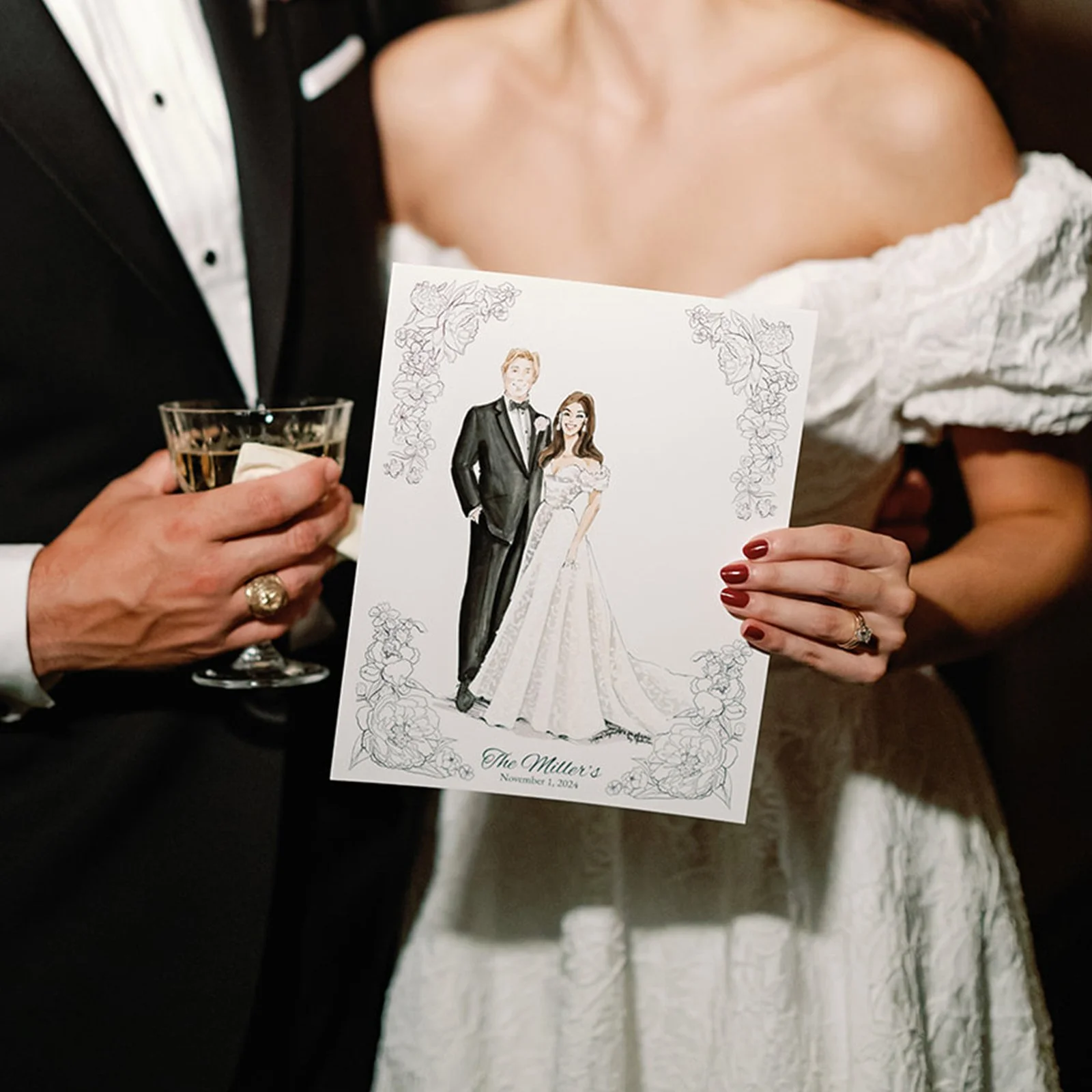Newlyweds holding their bespoke Vogue Vignette portrait — a custom illustrated keepsake created live on their wedding day, framed by a hand-drawn floral border.