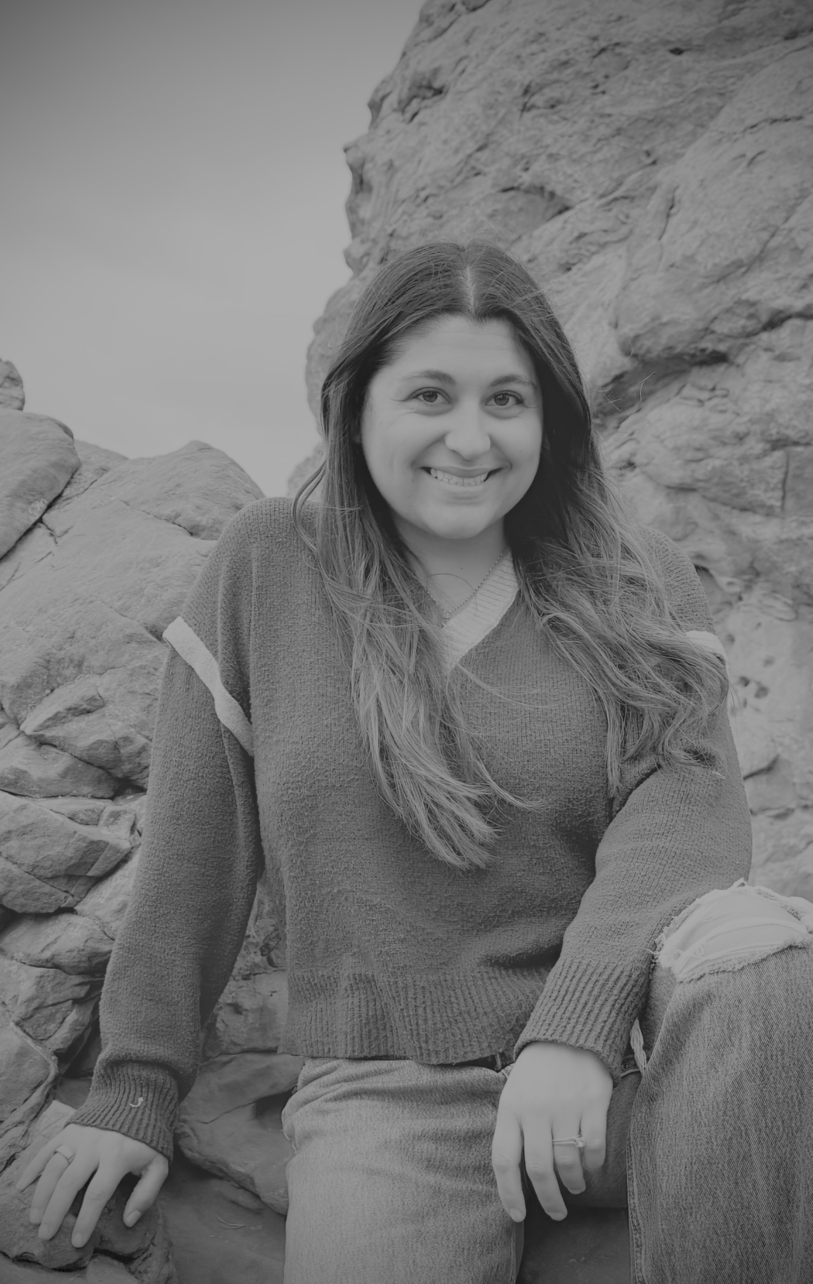 Black and white headshot of Latina and artist Carmen Mosnia Hodge in a mountain hillside setting.