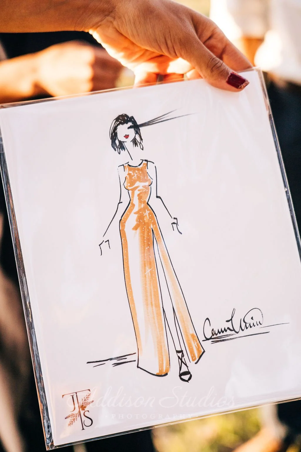 Ink and marker fashion illustration of a wedding guest in a gold dress by Carmen Mosnia Hodge. Photo by Addison Studio 