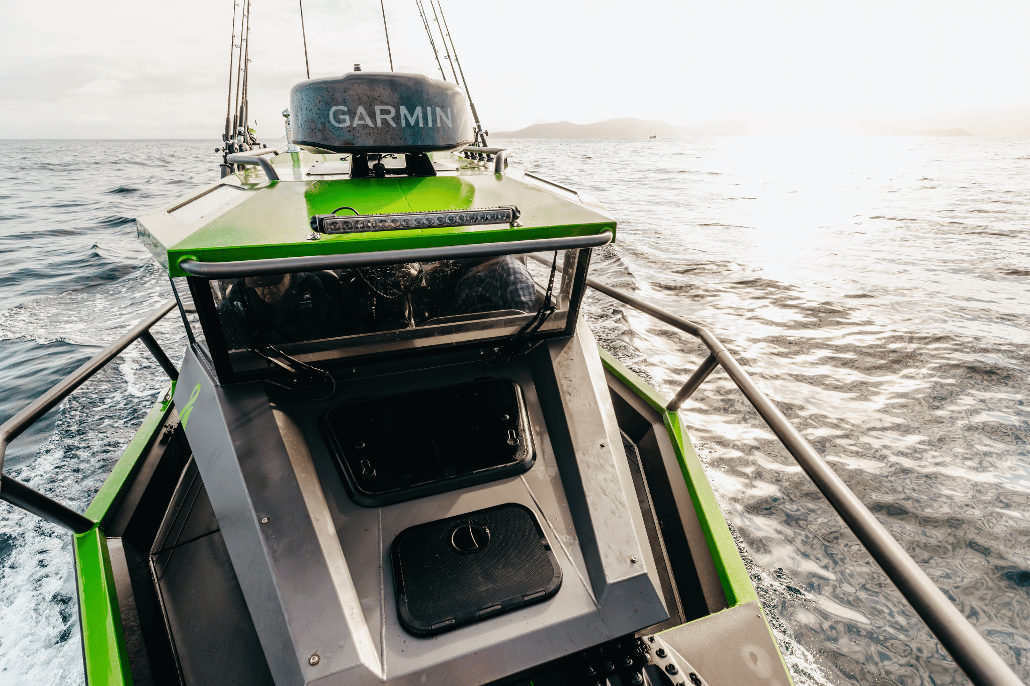 Photo from the bow of a StabiX boat on open water, with a Garmin marine radar atop the boat's dashboard.