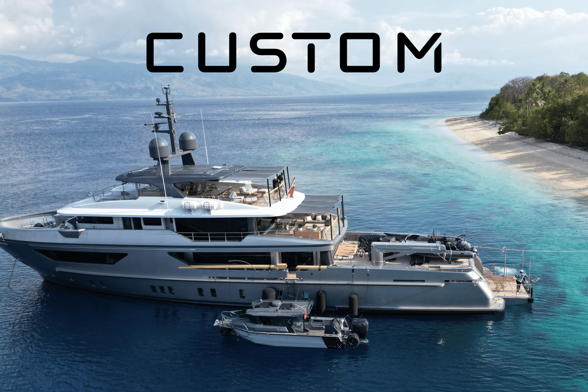 A large luxury yacht docked at a marina with a backdrop of mountains and a cloudy sky, showcasing that StabiX offers custom tender boats.