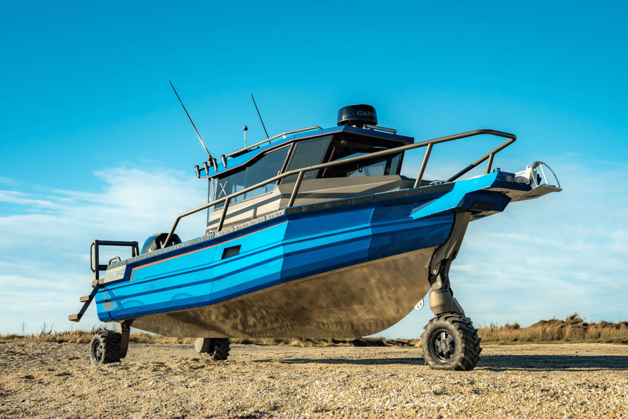 A StabiX 240CC fitted with the electric Tectrax system, parked on a sandy beach.