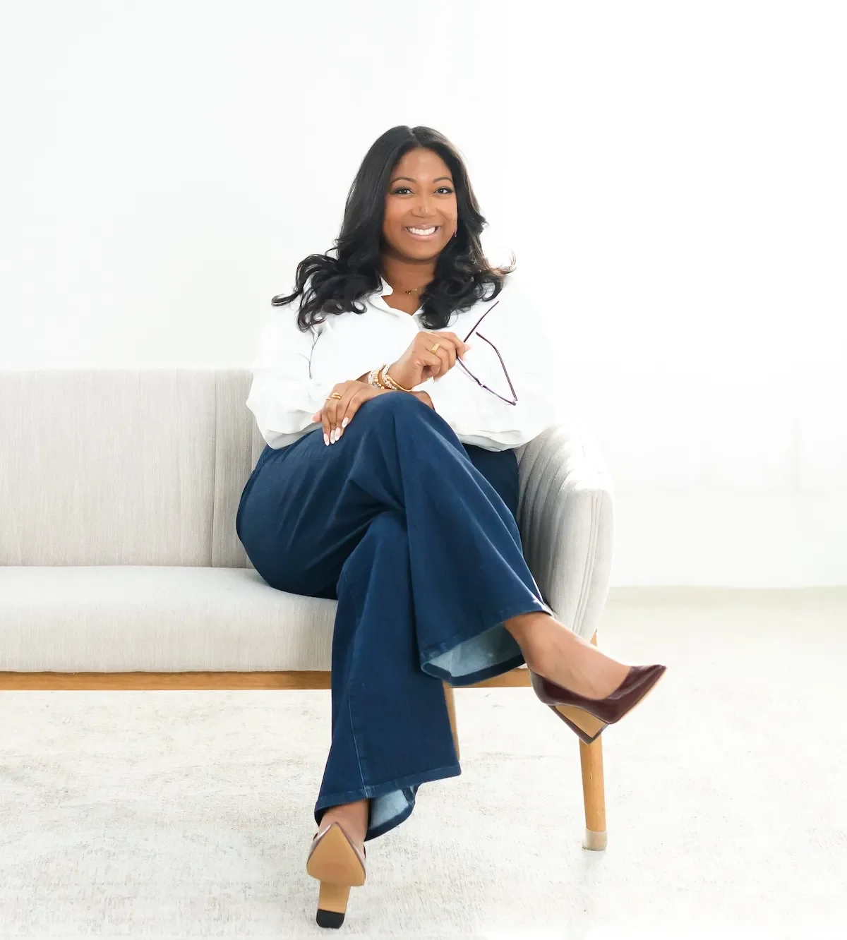 dr danielle graddick sitting on sofa smiling