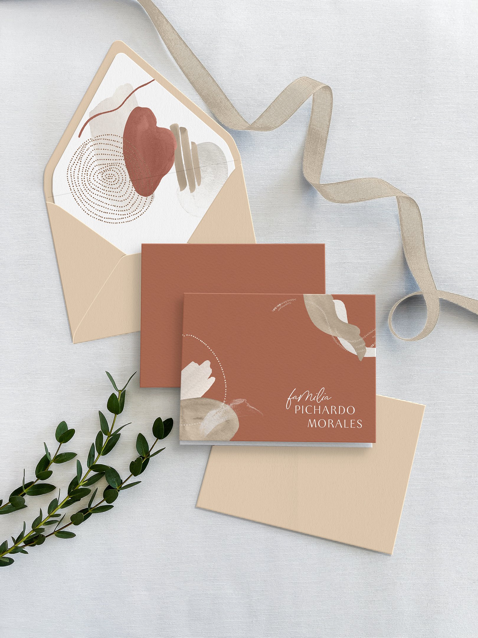 Abstract Terracotta personalized folded notecards set with coordinating envelopes and printed envelope liners.