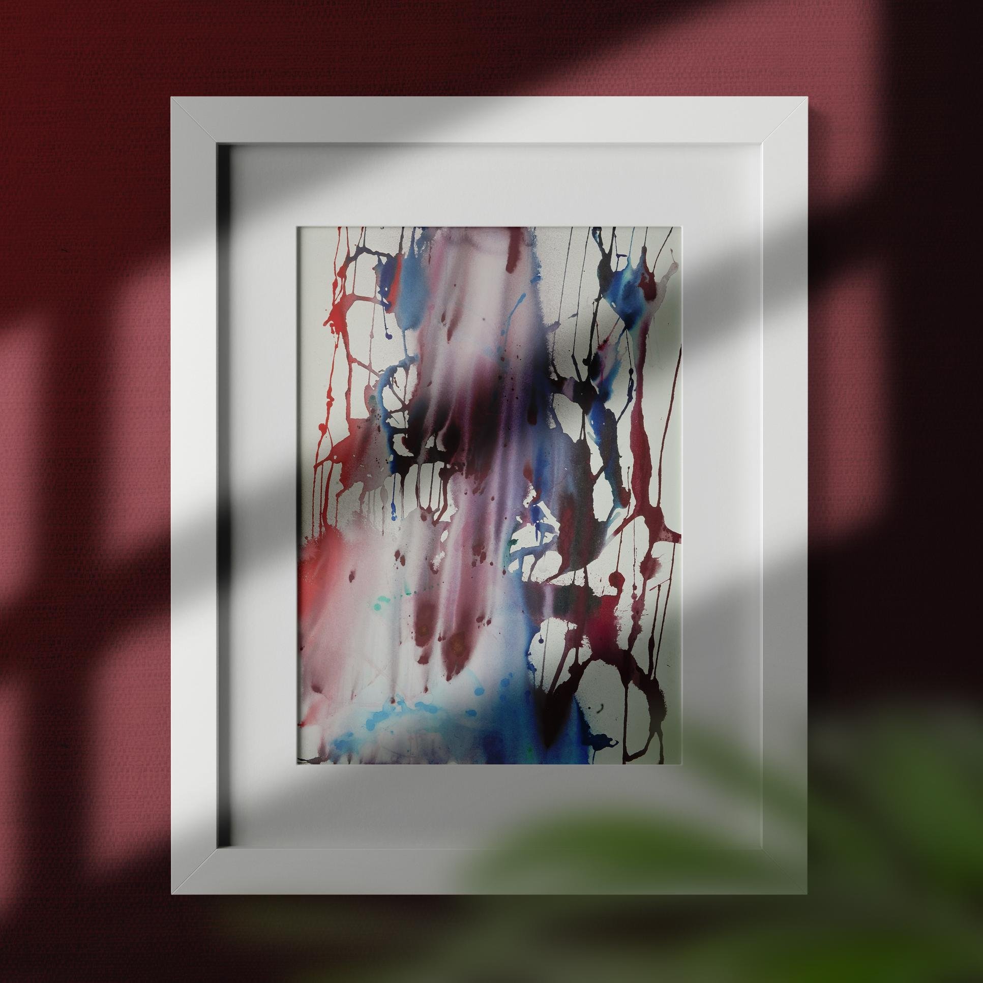 NY Sports Fan pops against a red-toned wall, its layered drips of color interacting with sunlight and shadow in a dramatic white frame.