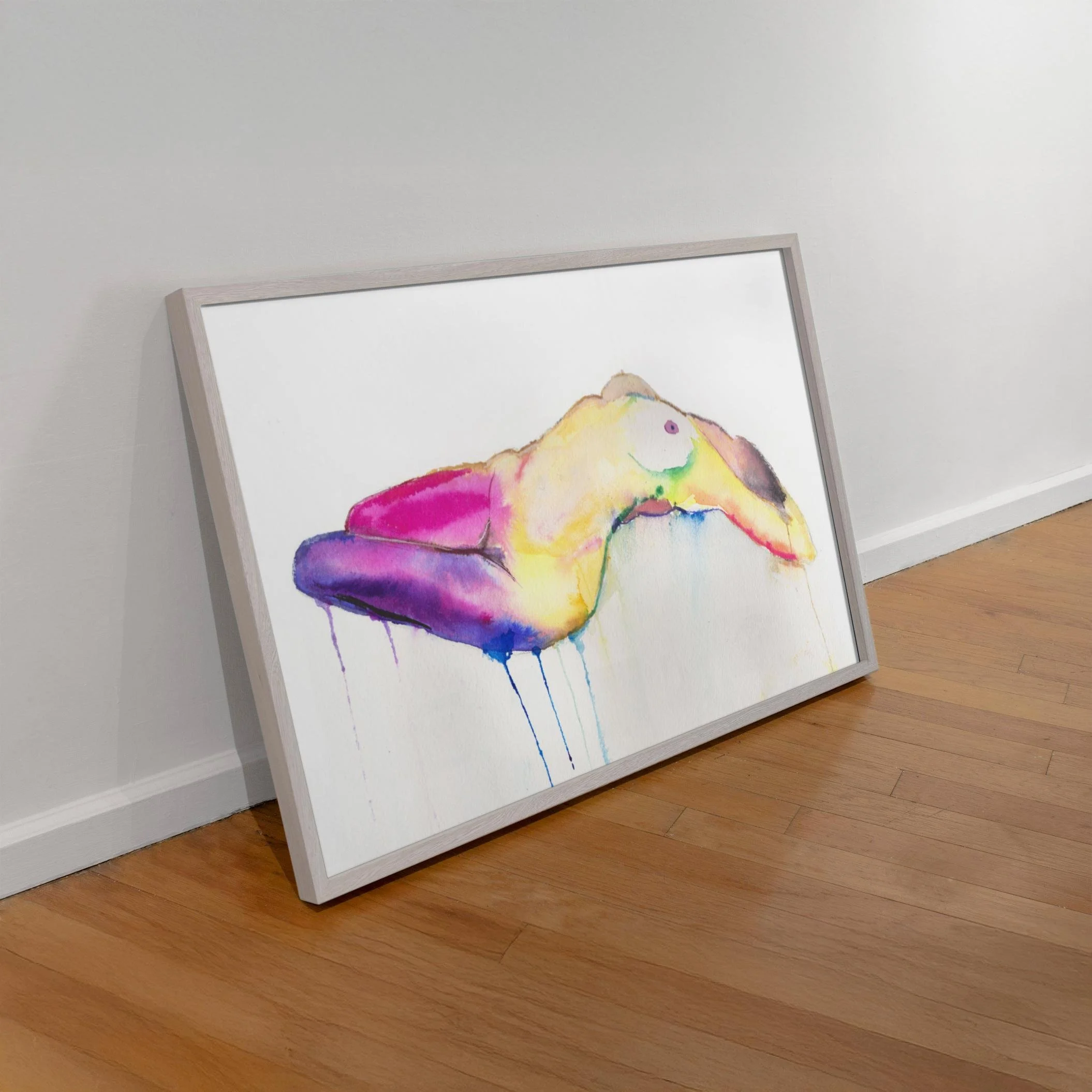 Lady Popsicle resting on a wood floor, unmounted in a light frame, showcasing its rich colors and drips from a relaxed angle.