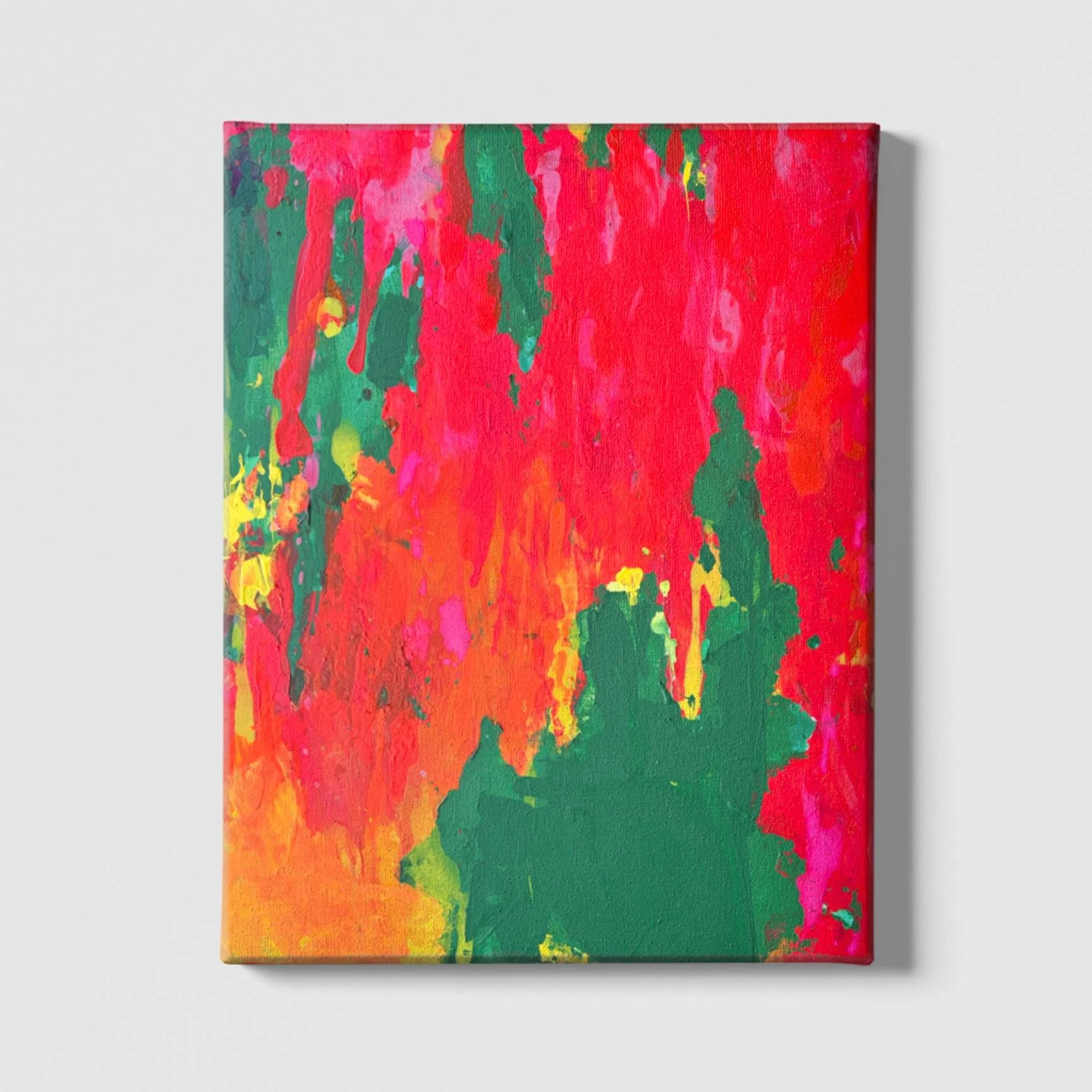 Bold abstract acrylic painting with fiery red, green, pink, and yellow colors on canvas