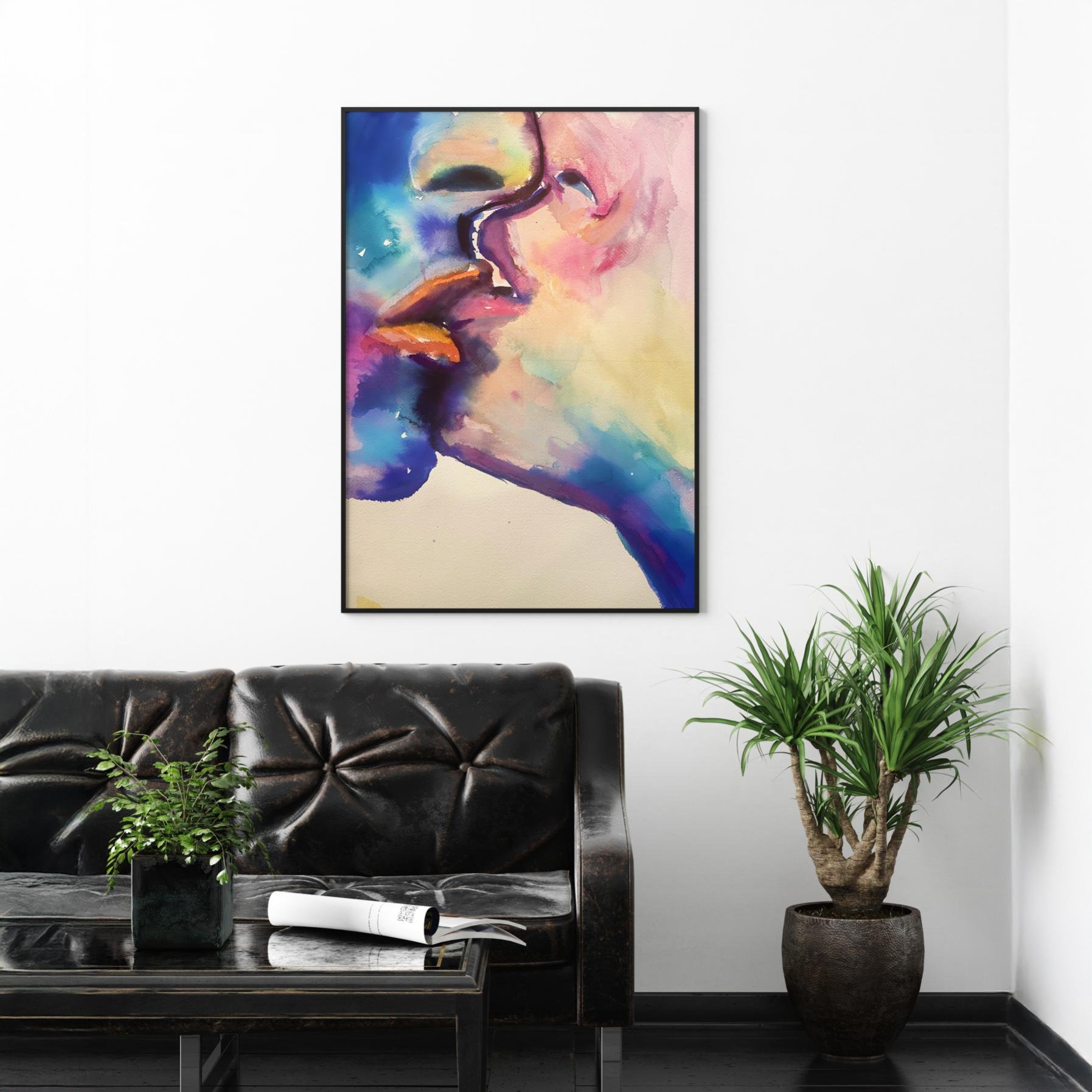Colorful watercolor kiss painting Lustful Bite styled in a contemporary living room above a black leather sofa and potted plant