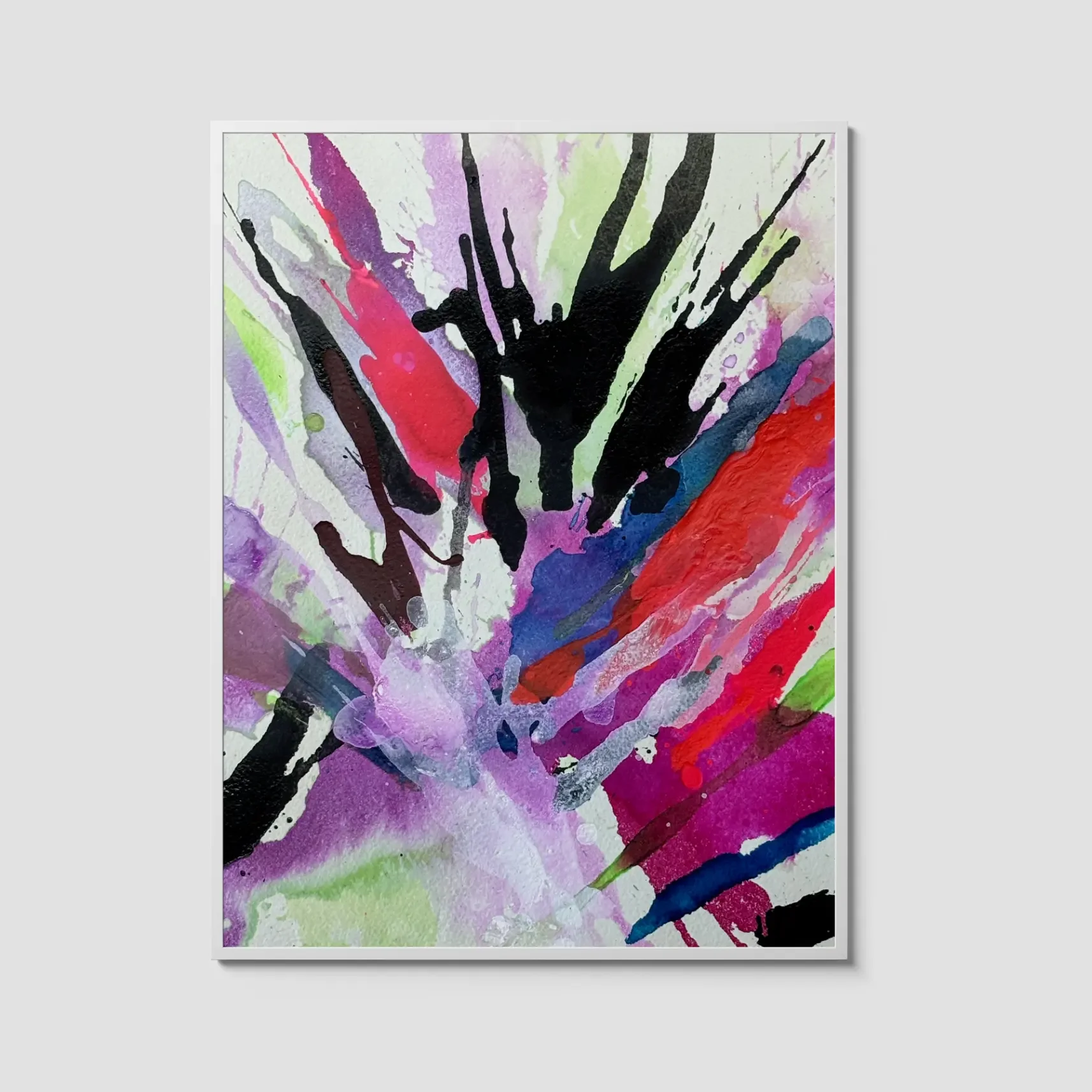 Abstract watercolor burst painting with bold black splashes and vibrant strokes of pink, purple, red, and green radiating across a textured background, displayed in a white frame.