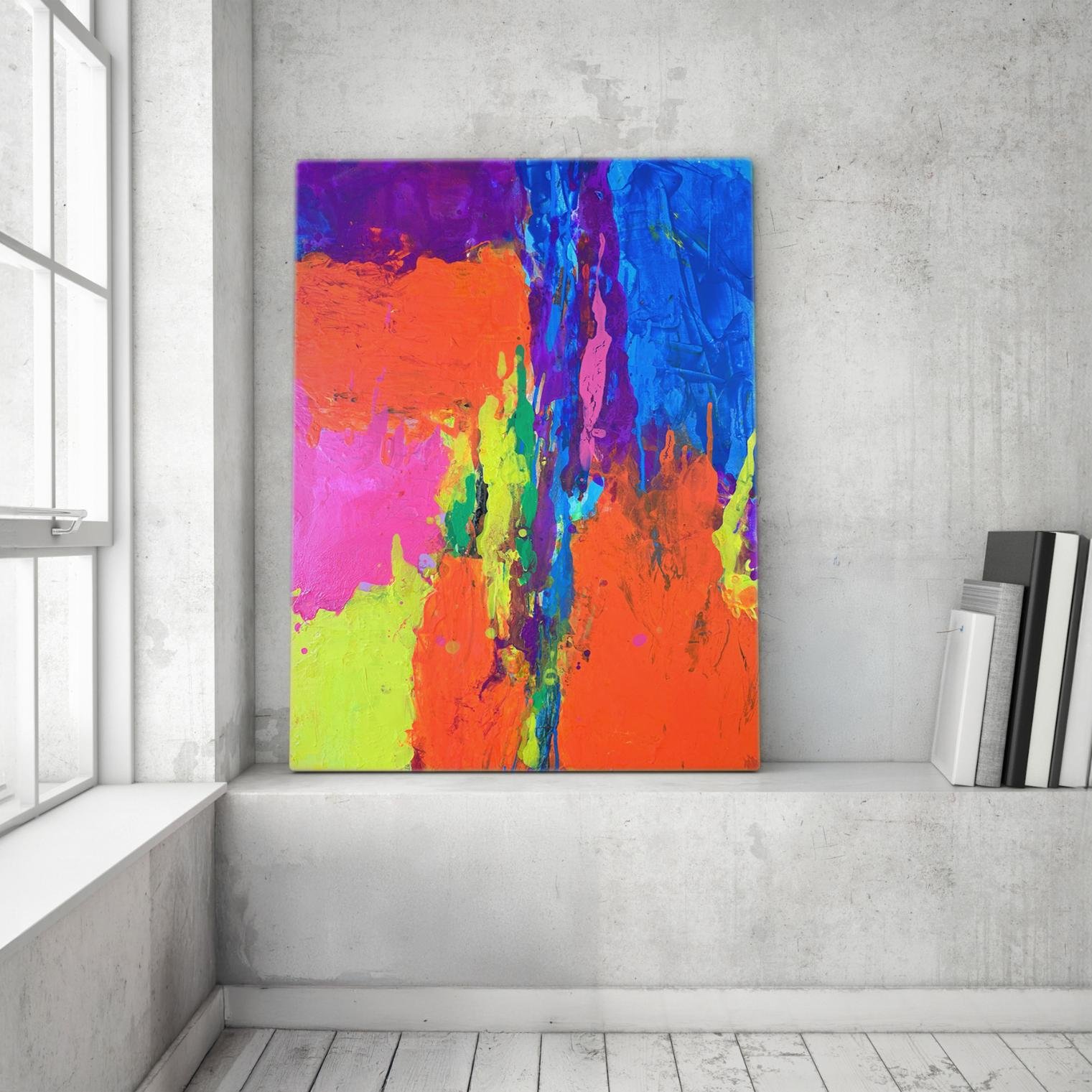 "Fusion" painting placed on a concrete ledge near a bright window, with a stack of books nearby, adding a splash of color to a modern loft.