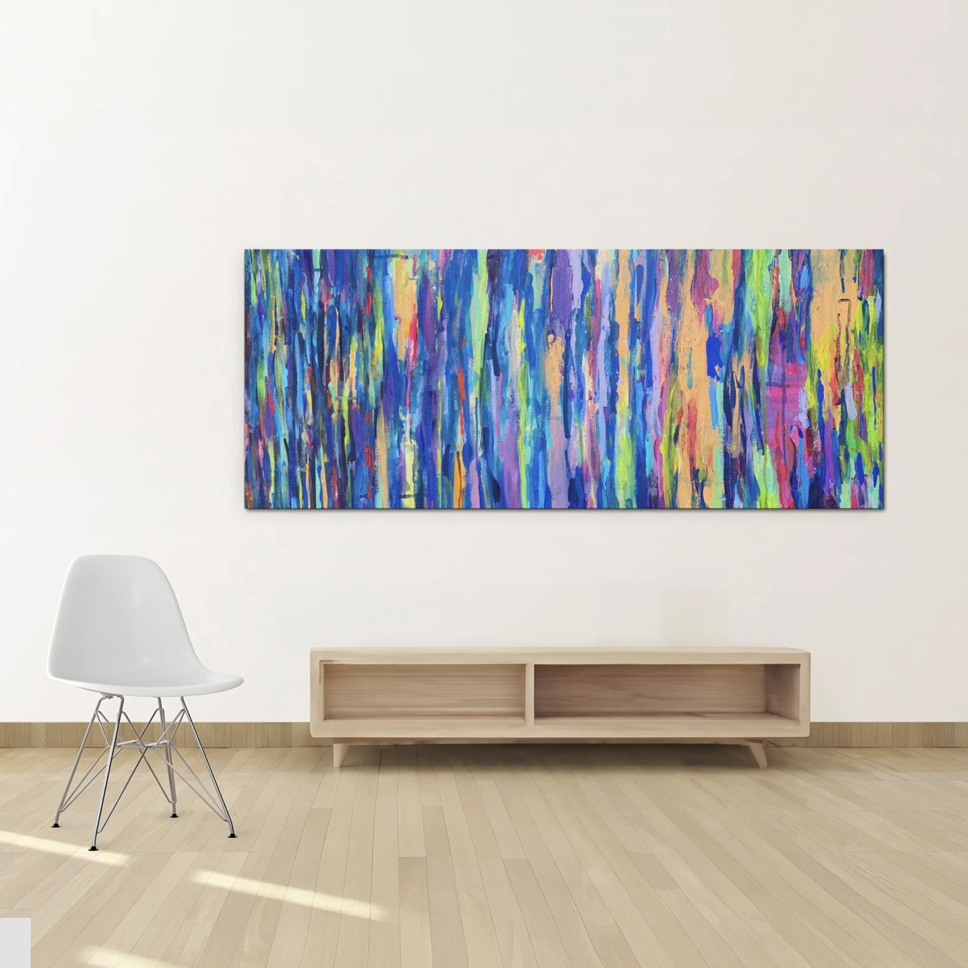 “Shimmer” displayed in a minimalist room above a light wooden console and white chair, highlighting its colorful vertical composition against a soft neutral wall.