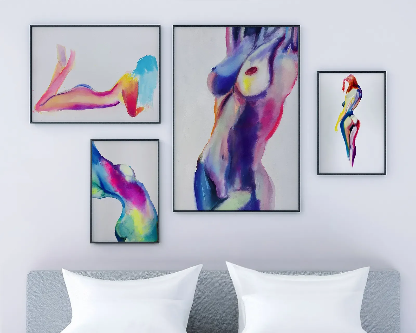 Gallery wall displaying colorful watercolor female nude paintings in modern frames above a bed by artist Nick Horvath.