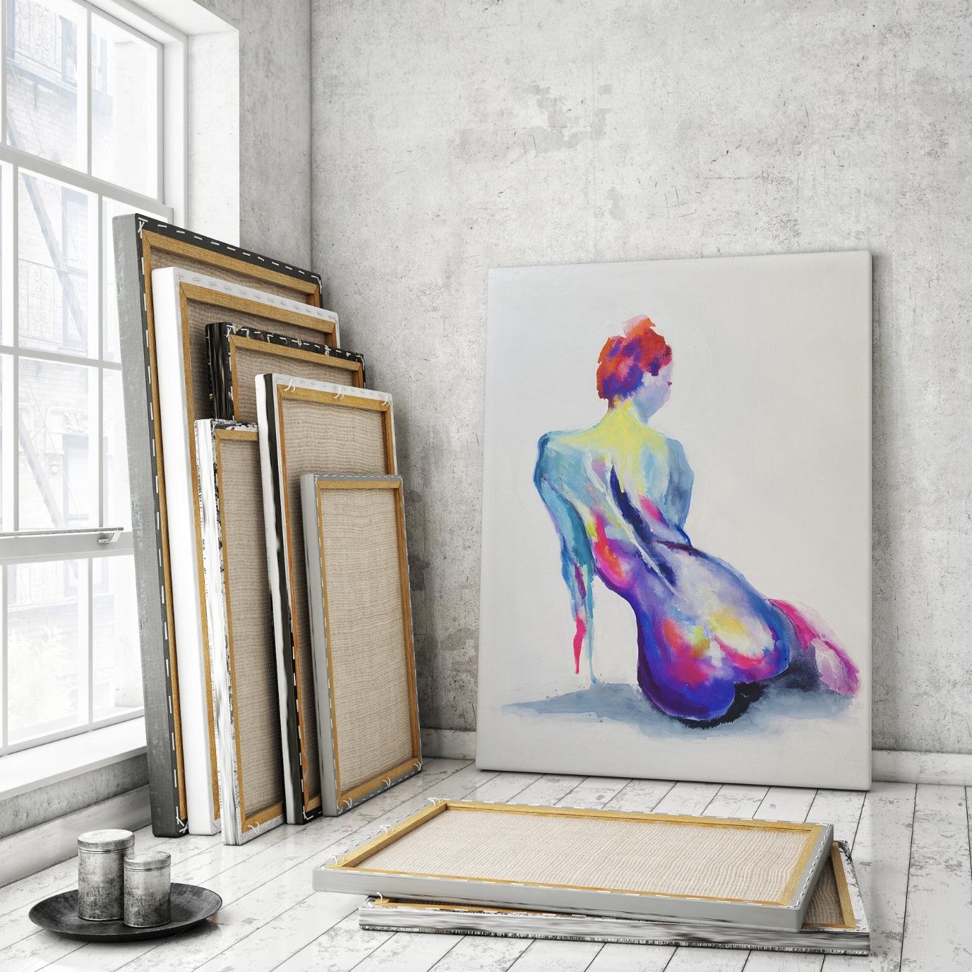 "Pastel Back" painting leaning against a concrete wall, surrounded by stacked canvases and natural light from a large window.