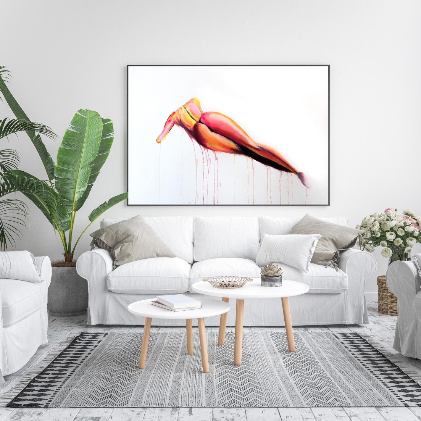 “Orange Back” framed above a white sofa with neutral-toned cushions and green plants, creating a vibrant focal point in a bright living space.