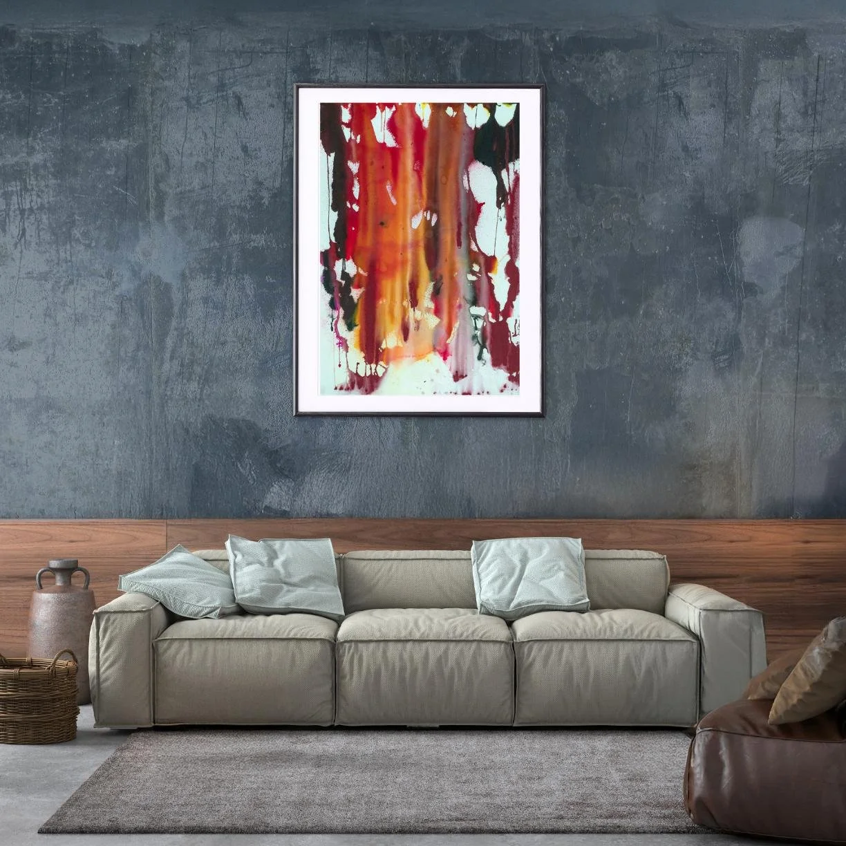 “Summer Sweat” painting above a beige modern couch in a moody living room with dark concrete walls.