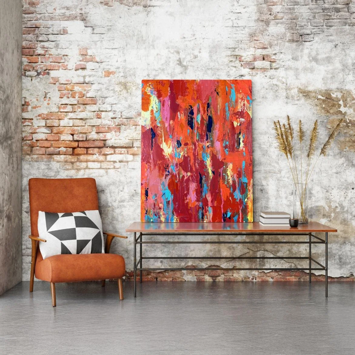 Ember resting on a console table in a stylish industrial room, with a rustic brick wall, modern chair, and decorative books and vase.