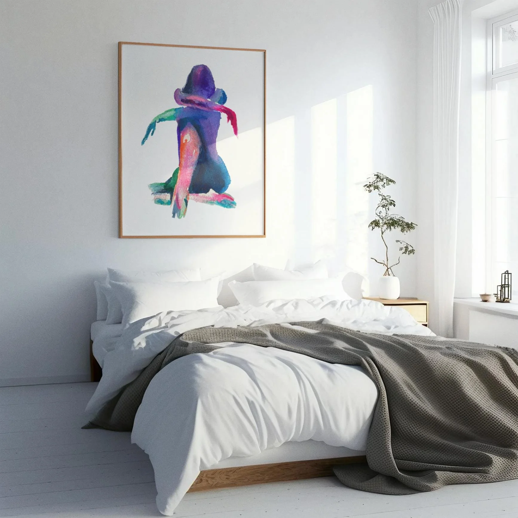 “Resting” artwork adds bold color and softness to a white minimalist bedroom; abstract nude in vibrant watercolor tones.