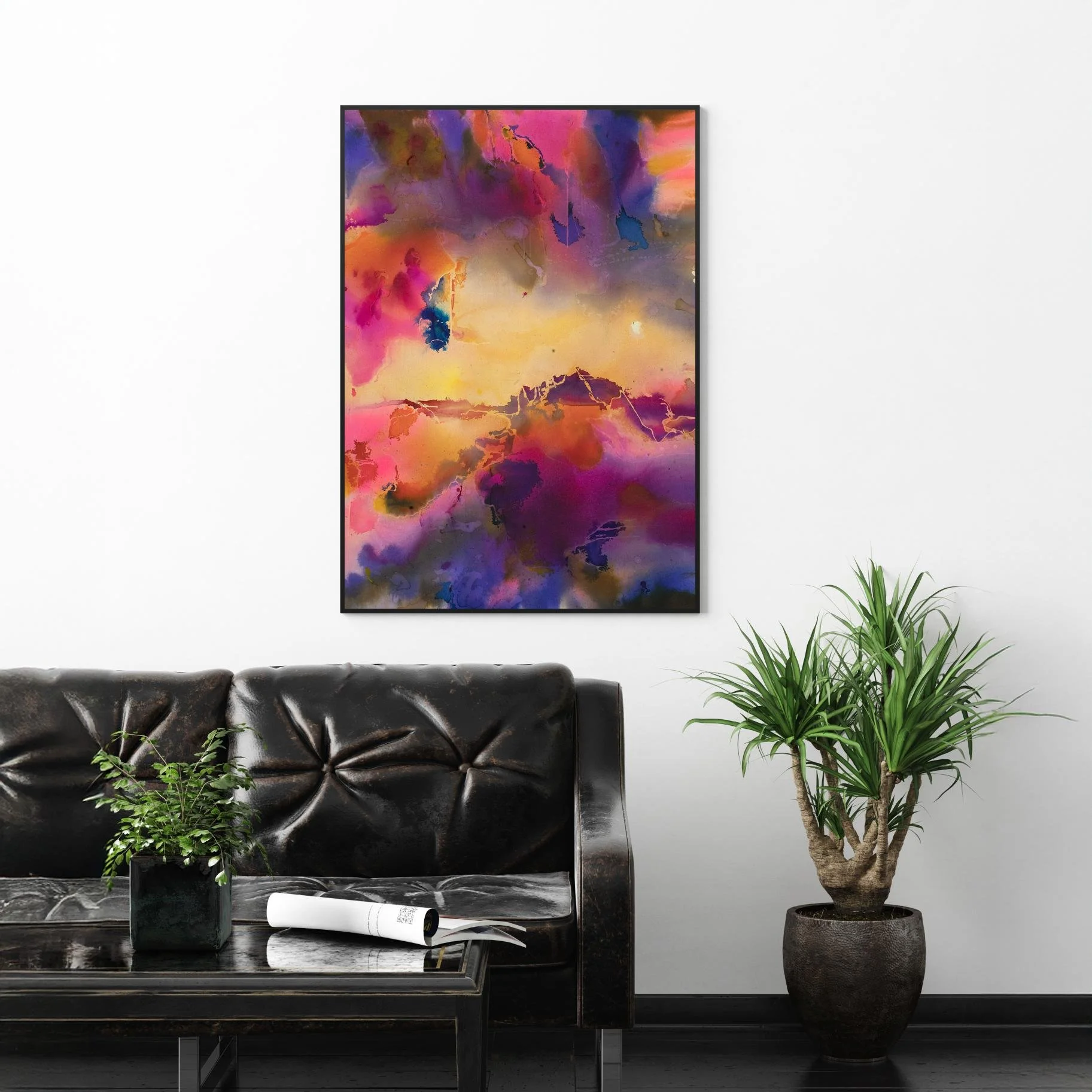 Dreamy abstract painting hanging above a black tufted leather sofa with indoor plants on both sides.