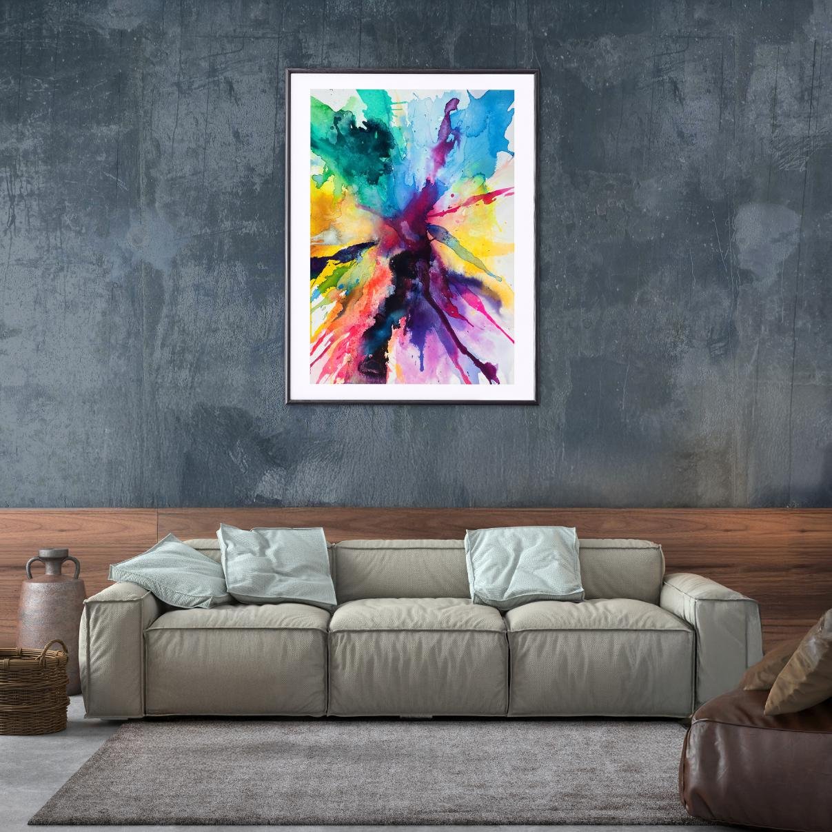 The abstract watercolor is displayed in a black frame above a beige couch against a moody dark grey wall, offering a dramatic and modern presentation.