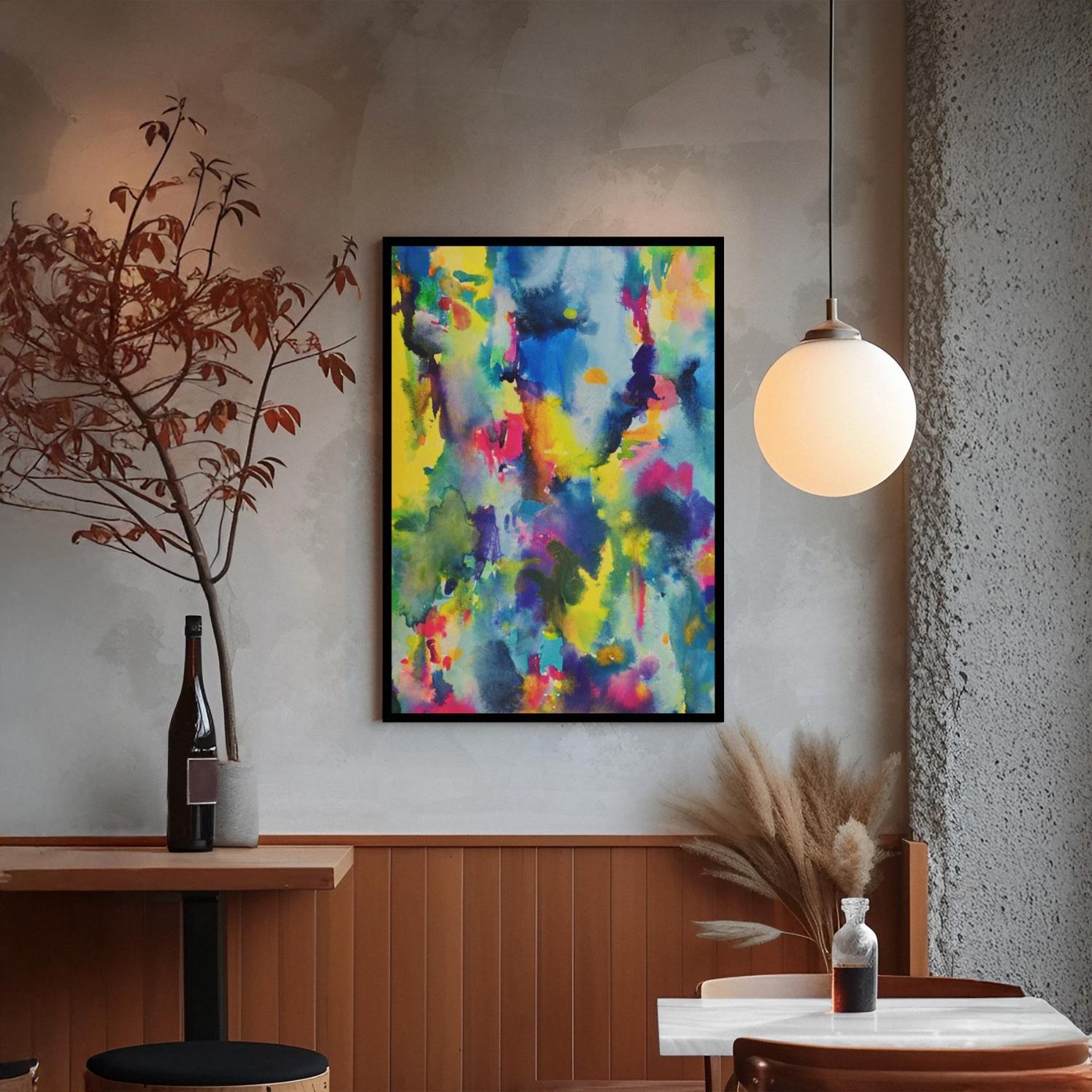 A framed abstract energizes a warm interior, echoing dusk tones through its expressive blend of saturated yellows, violets, and forest greens.