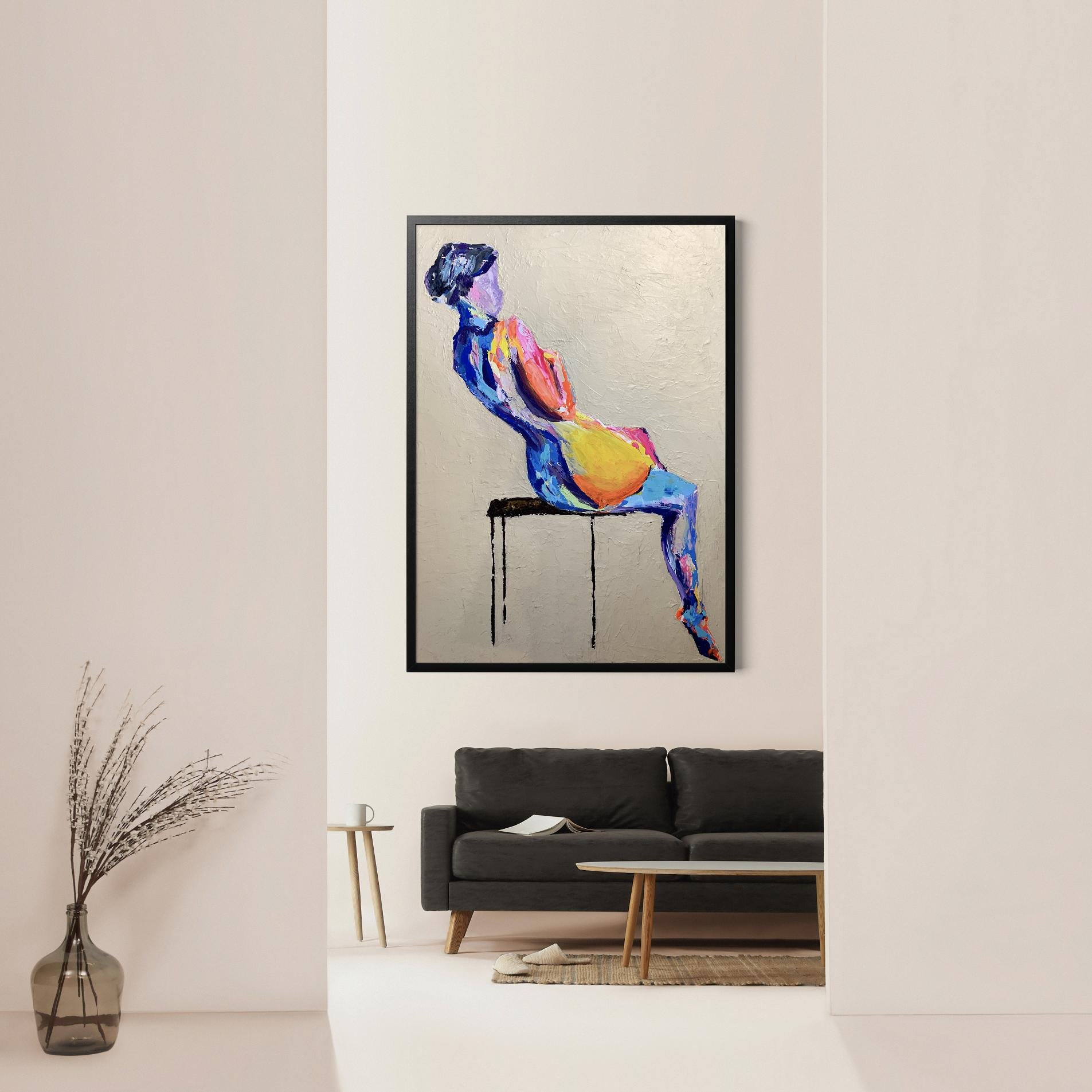 "Reflections" painting displayed in a sleek modern living room with neutral walls and a dark gray sofa, emphasizing the artwork’s dynamic color against a clean, minimal space.